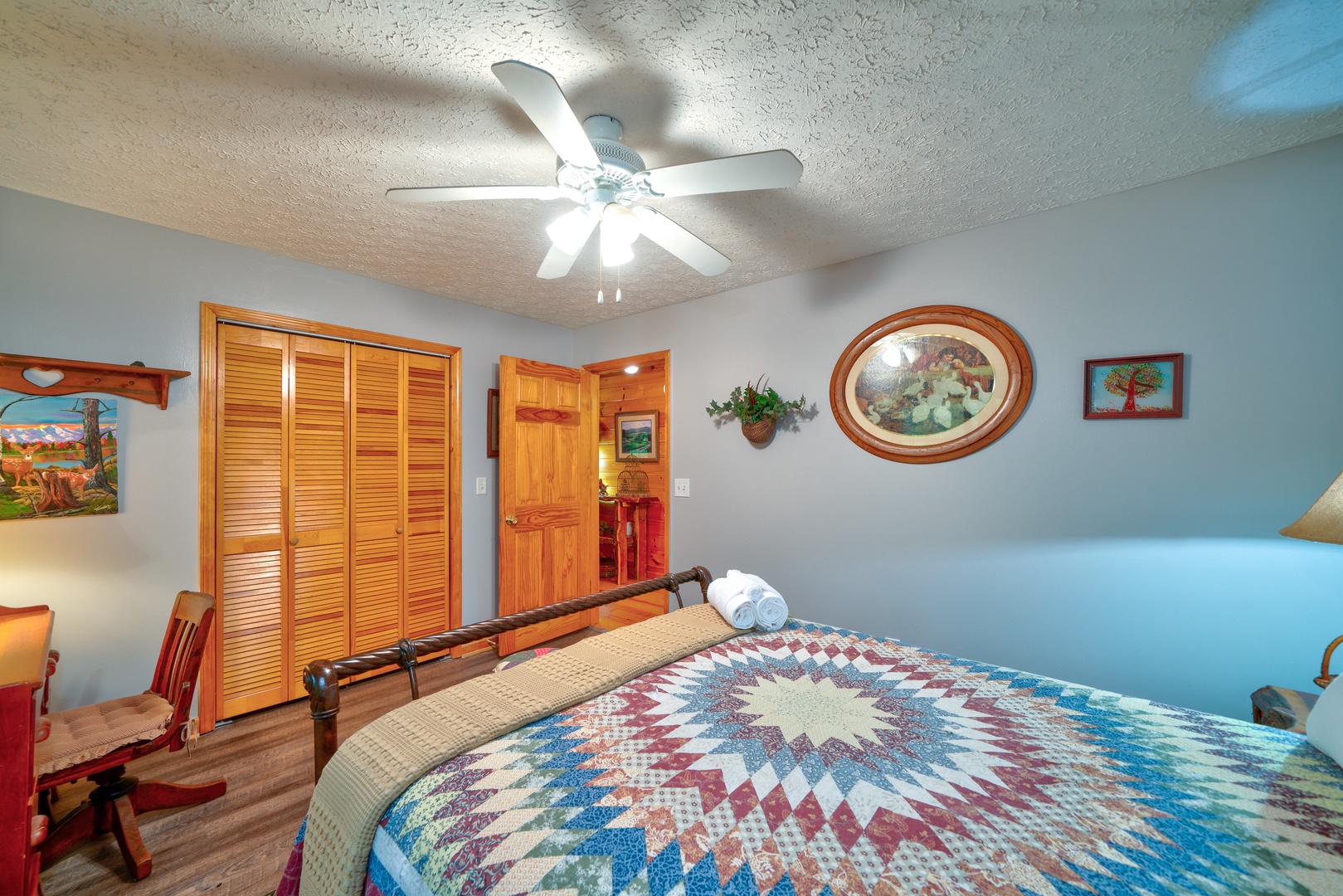 This serene main-level bedroom includes a plush queen-sized bed