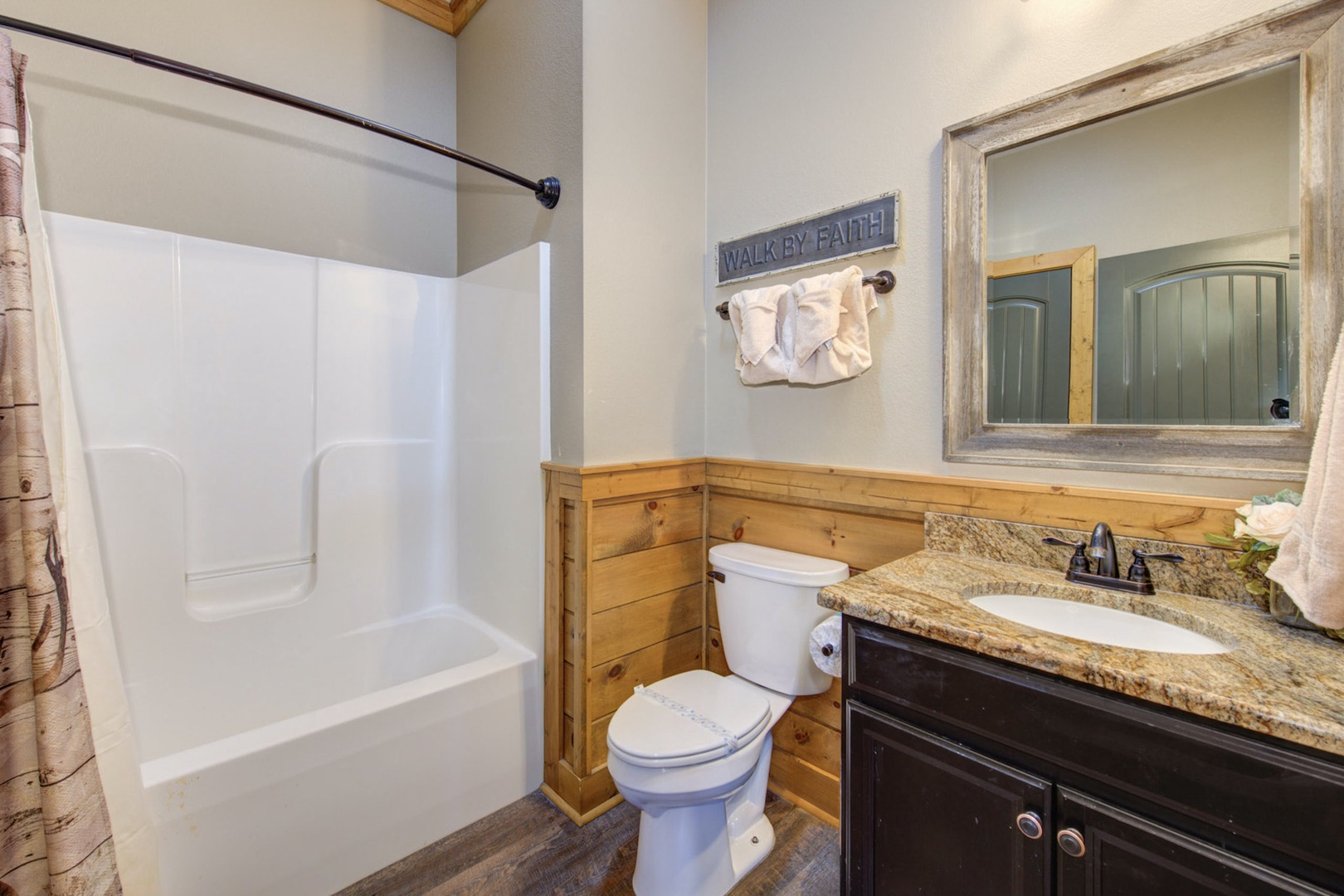 This ensuite bathroom includes a single vanity & shower/tub combo