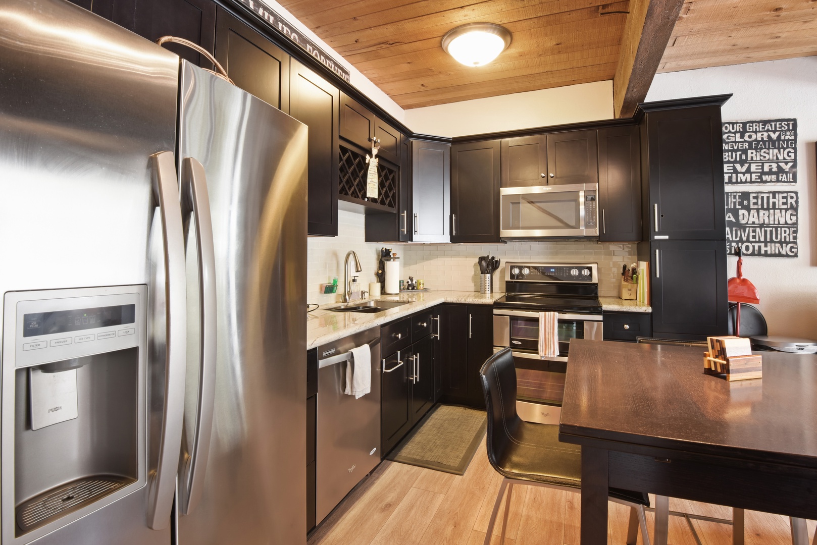 Modern kitchen with stainless steel appliances, drip coffee maker, knife set and more