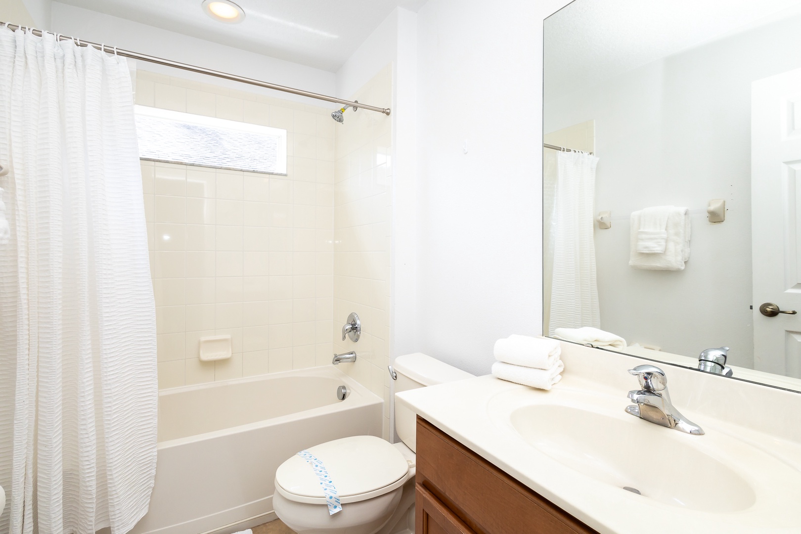 The upstairs shared full bath includes a single vanity & shower/tub combo