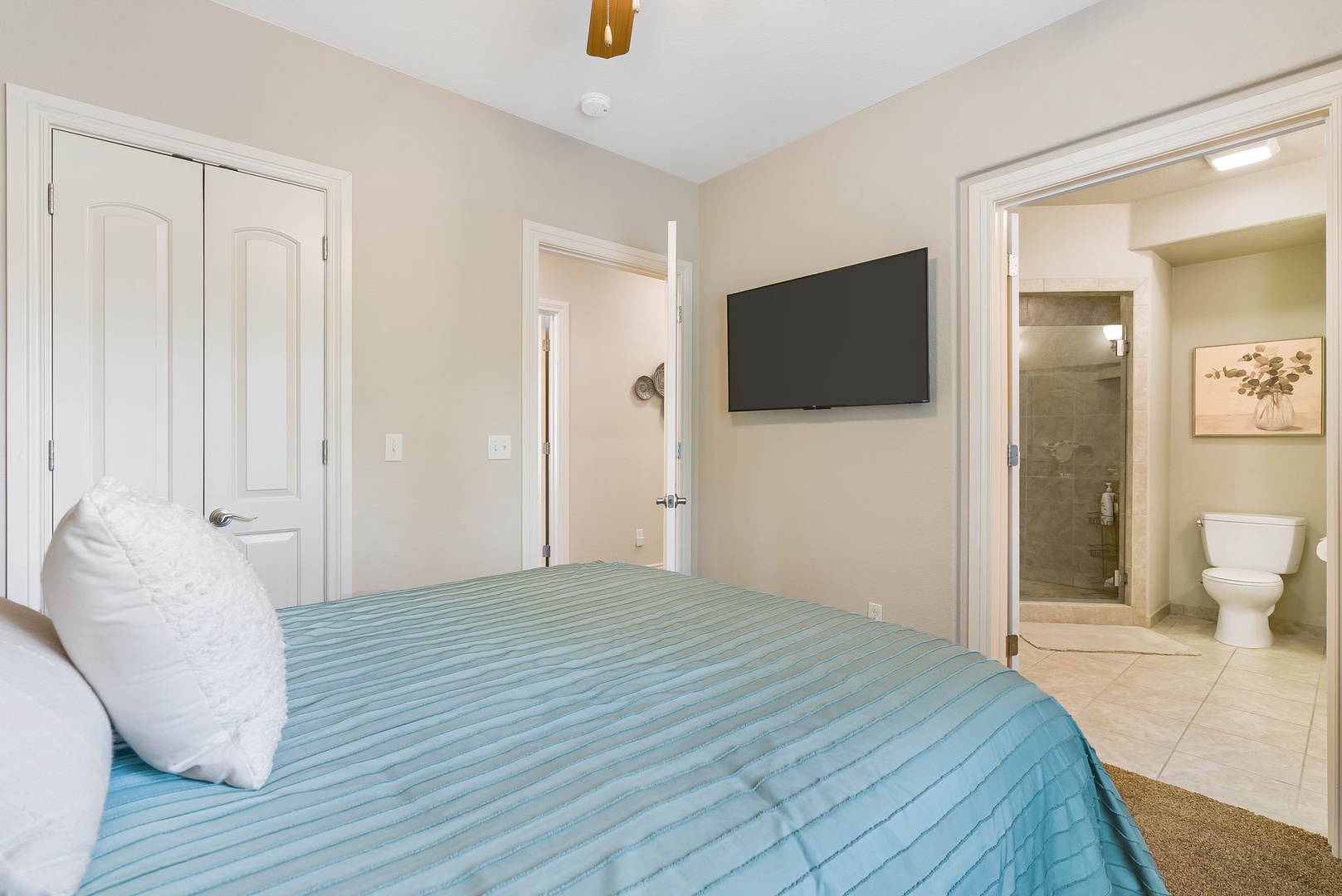 Bedroom 1 with Queen bed, TV, and en-suite