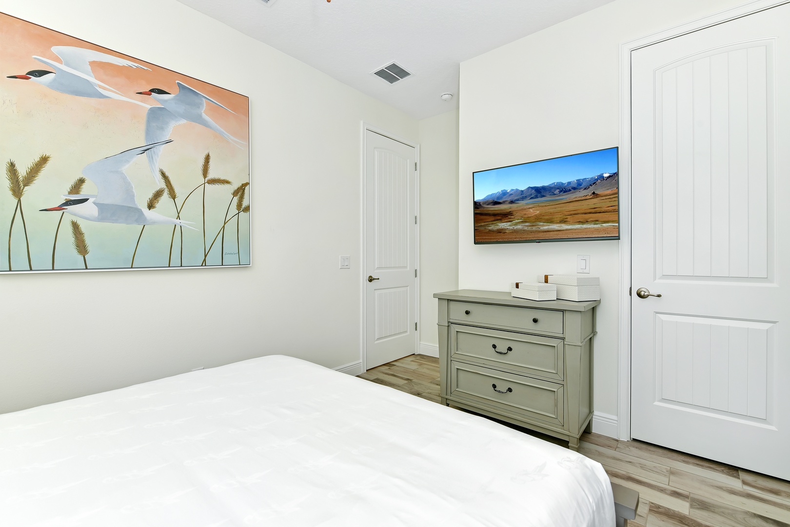 Coastal elegance awaits in this main-level queen bedroom