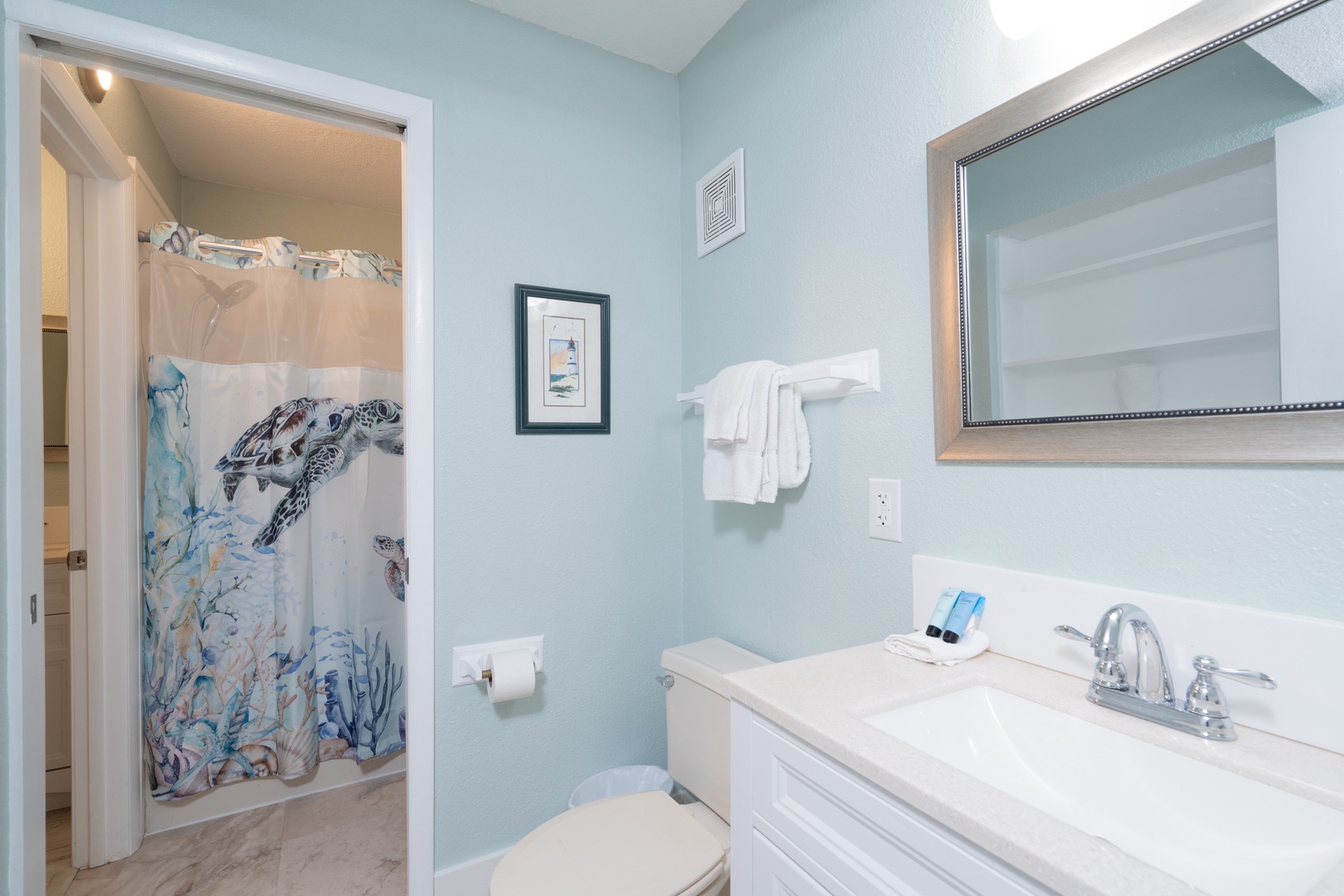 The home’s full bath features a single vanity & shower/tub combo