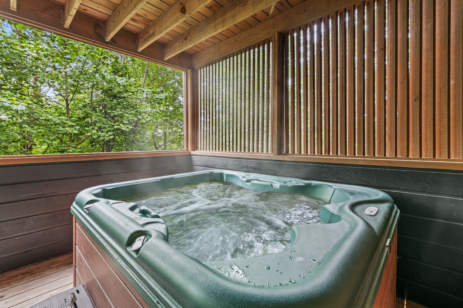 A secluded hot tub offering a tranquil escape surrounded by nature