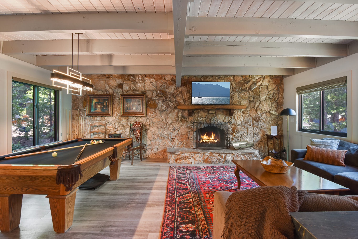 Cozy and spacious living area with Pool Table, TV, and Fireplace