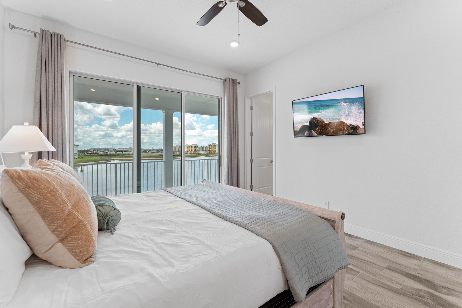 Coastal charm: King bed, smart TV, and balcony with water view