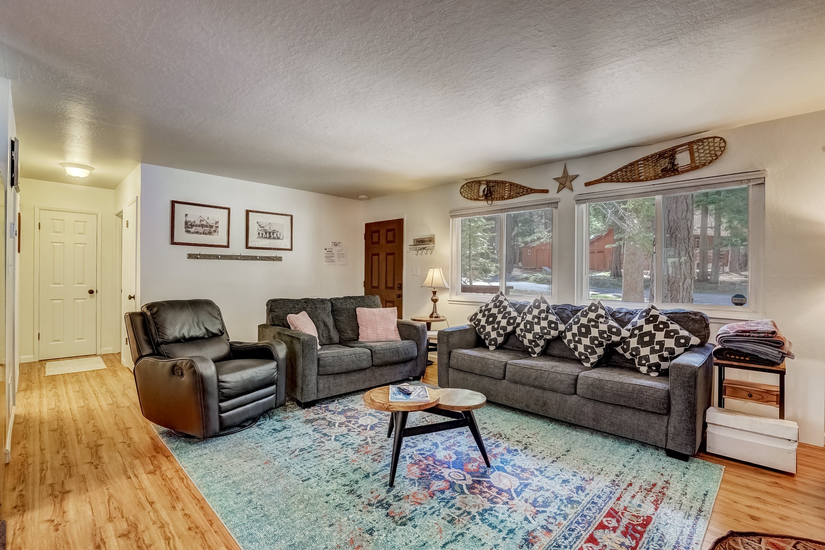 Living room with Roku TV, wood burning fireplace and comfortable seating