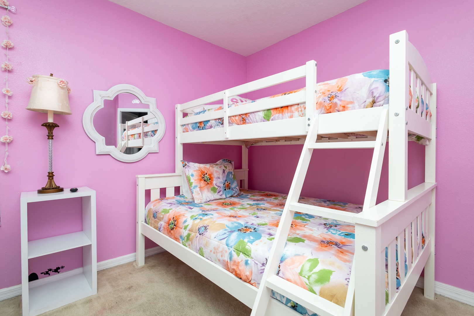 This 2nd floor princess-themed bedroom has a twin-over-full bunk bed & an additional twin bed