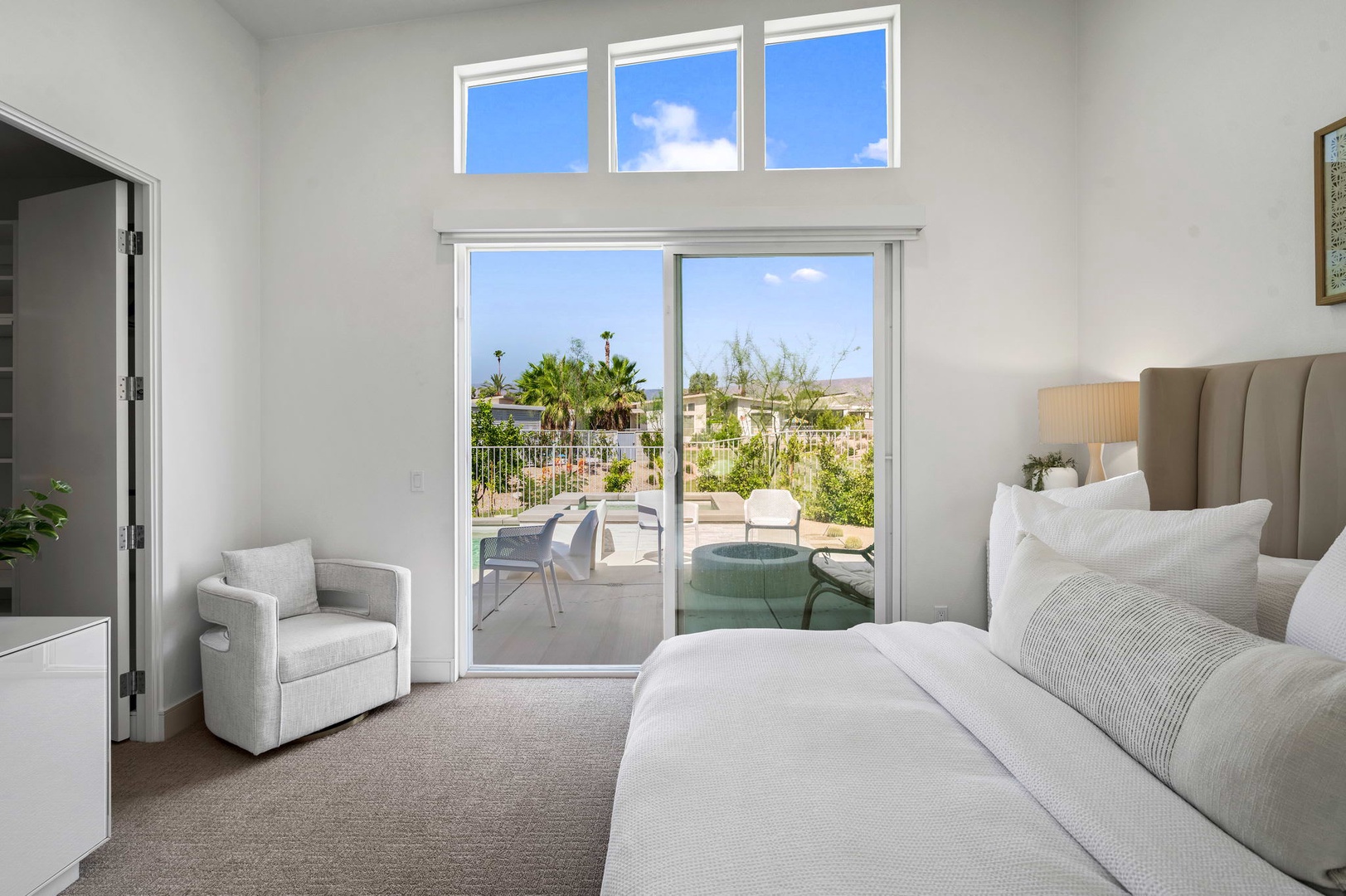 Bedroom 1 with King bed, TV, patio access, and private en-suite