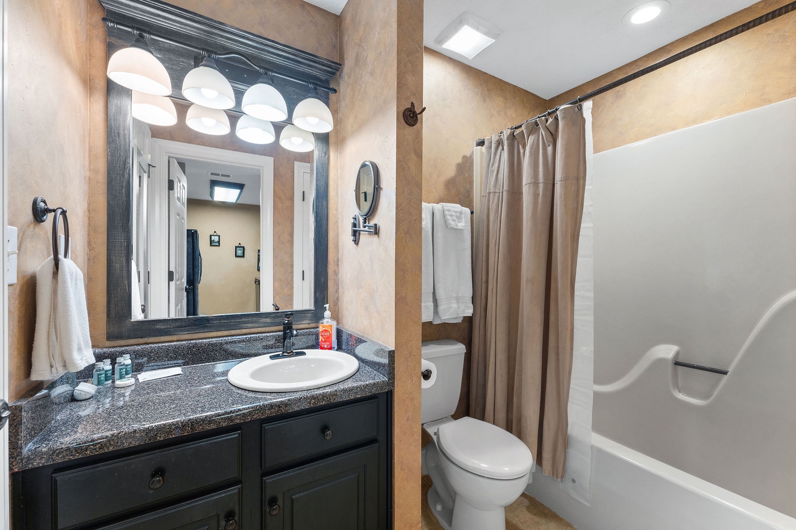 A single vanity & shower/tub combo await in the ensuite bath