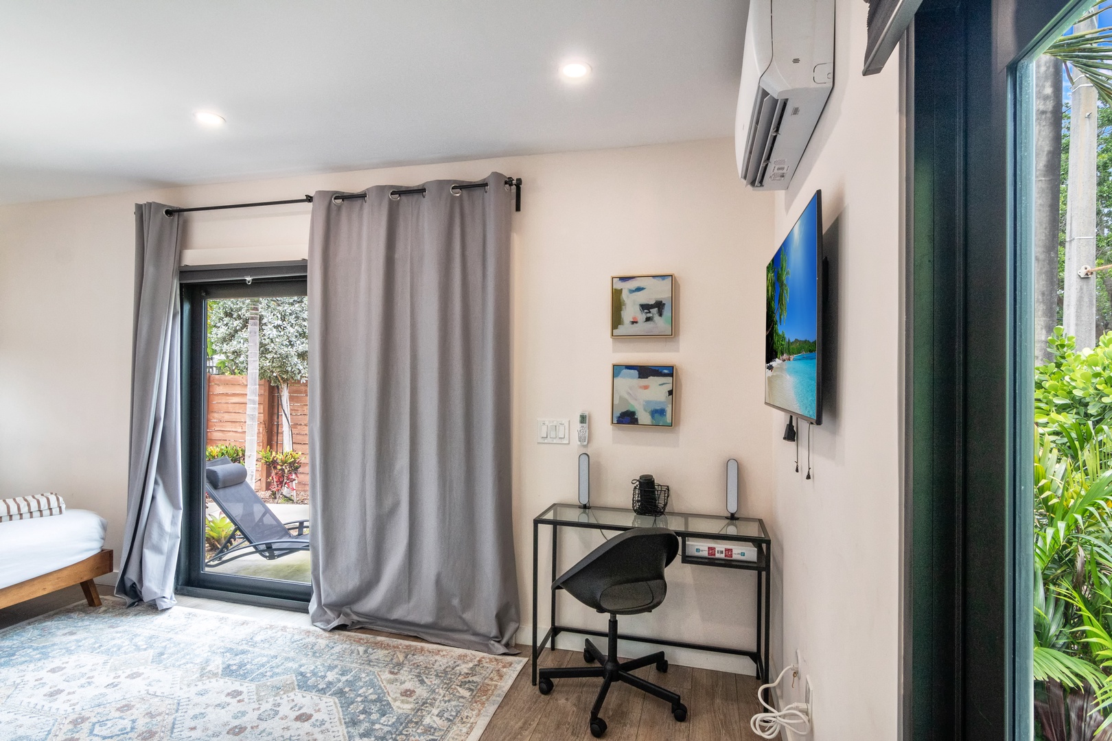 Bedroom with queen bed, work station, Smart Tv and patio access