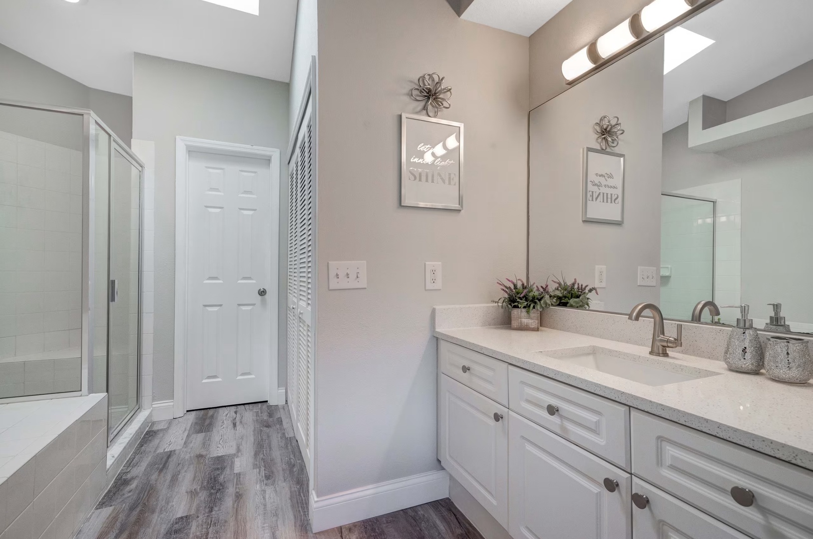 An oversized vanity, shower and soaking tub await in this large ensuite bath