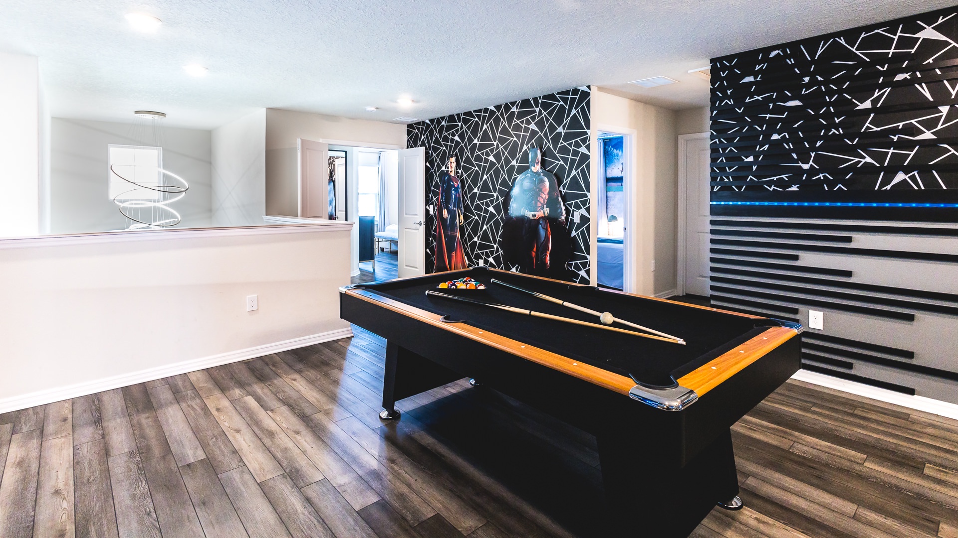 Super Hero game room area with pool table, seating, and Smart TV