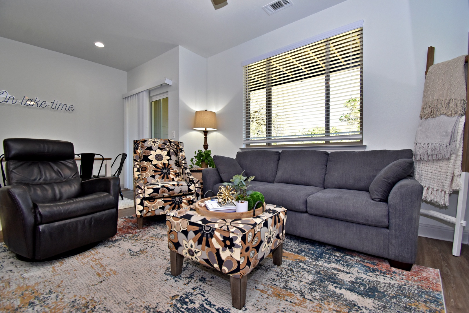 Open living space with ample seating, Smart TV, and patio access