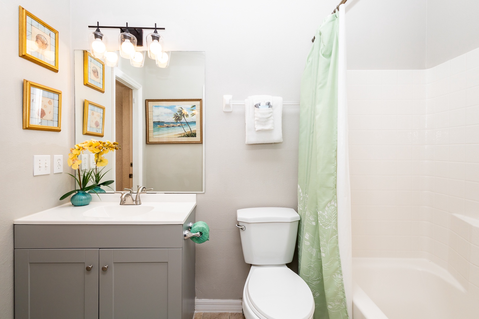 Wash up in this ensuite, featuring a single vanity & shower/tub combo