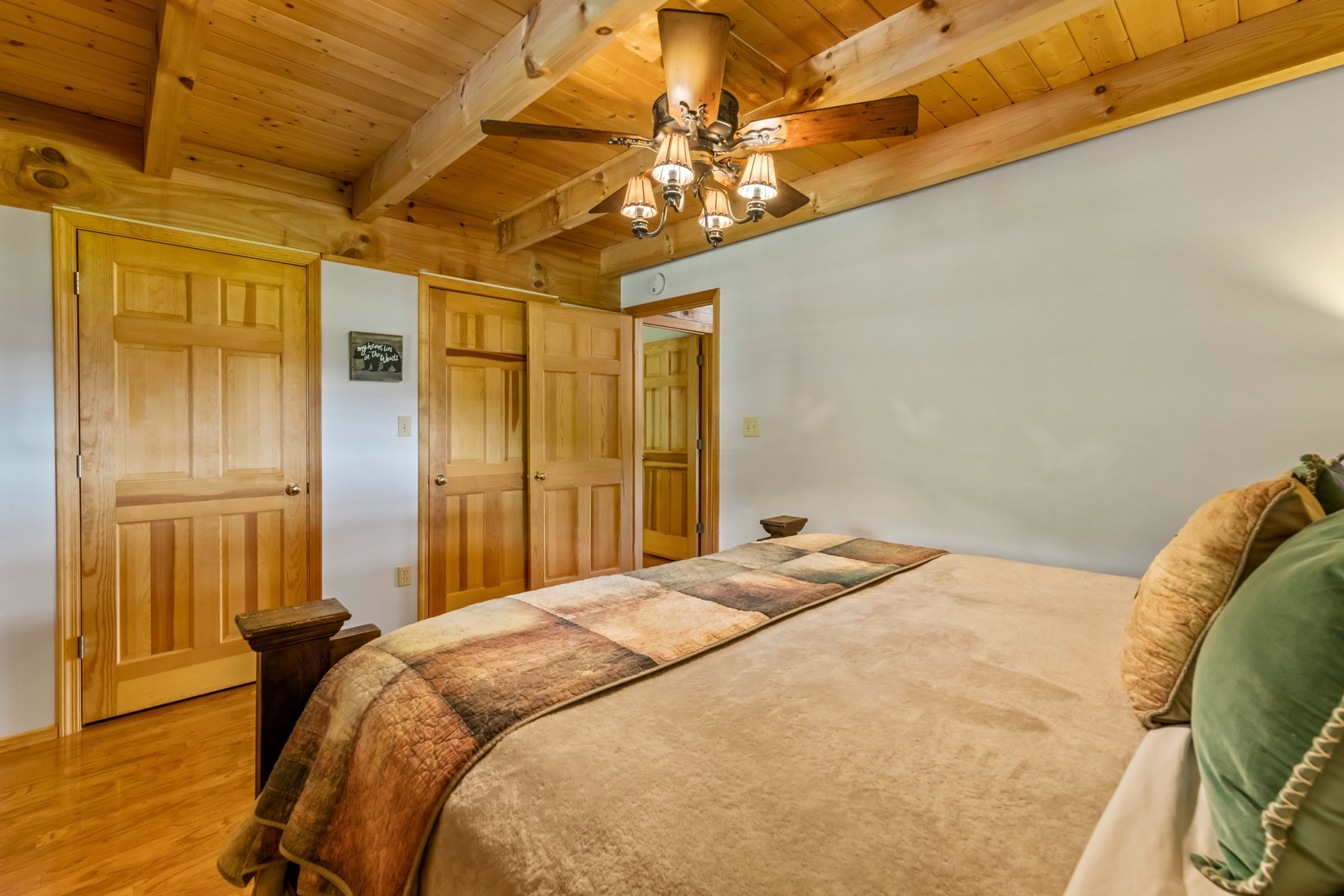 The first of two main-level bedrooms boasts a regal king-sized bed