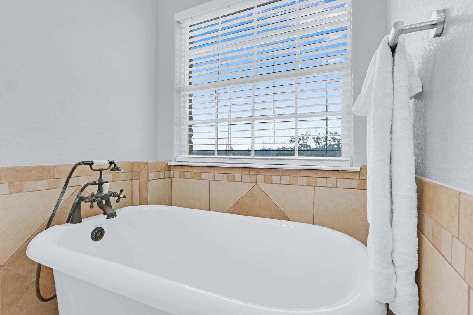 The king ensuite showcases a double vanity, walk-in shower, & soaking tub