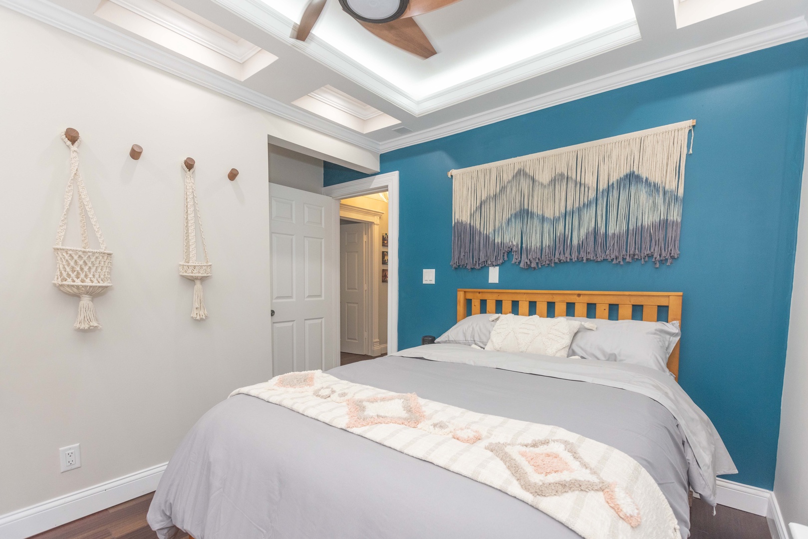 This 2nd floor main house queen bedroom includes a Smart TV & ceiling fan