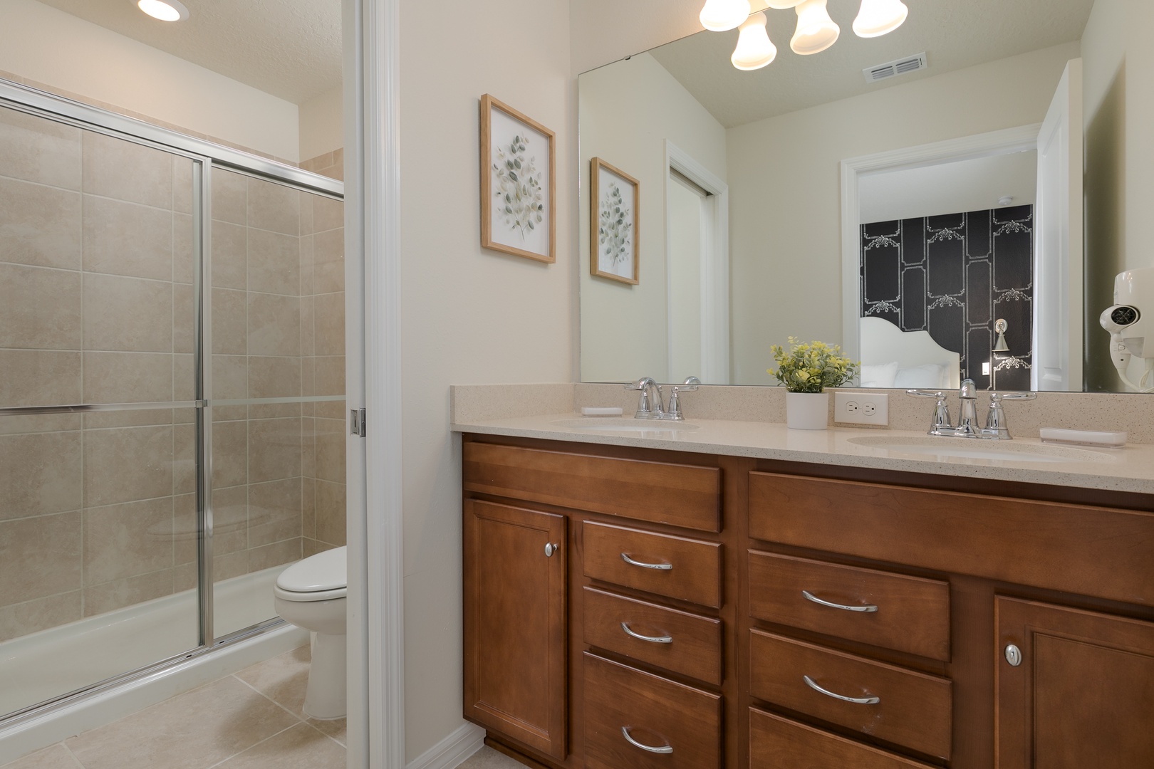 This private en suite includes a double vanity & glass walk-in shower