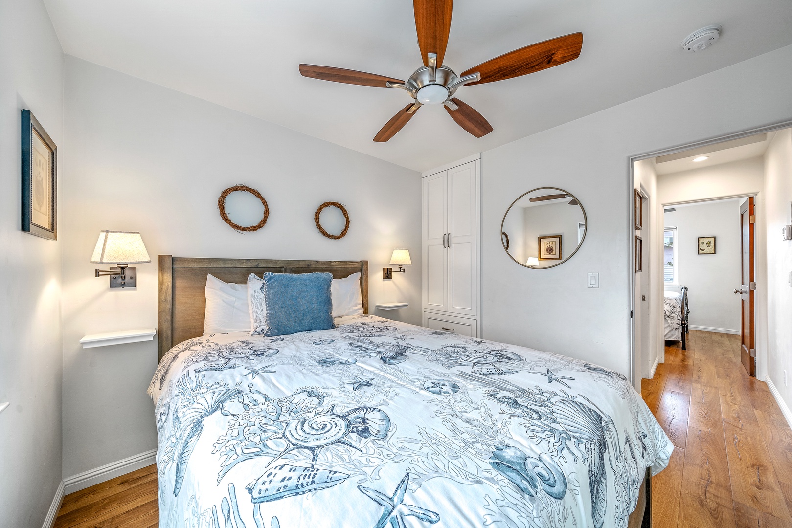 The 1st of 2 bedrooms offers a comfy queen bed & ceiling fan