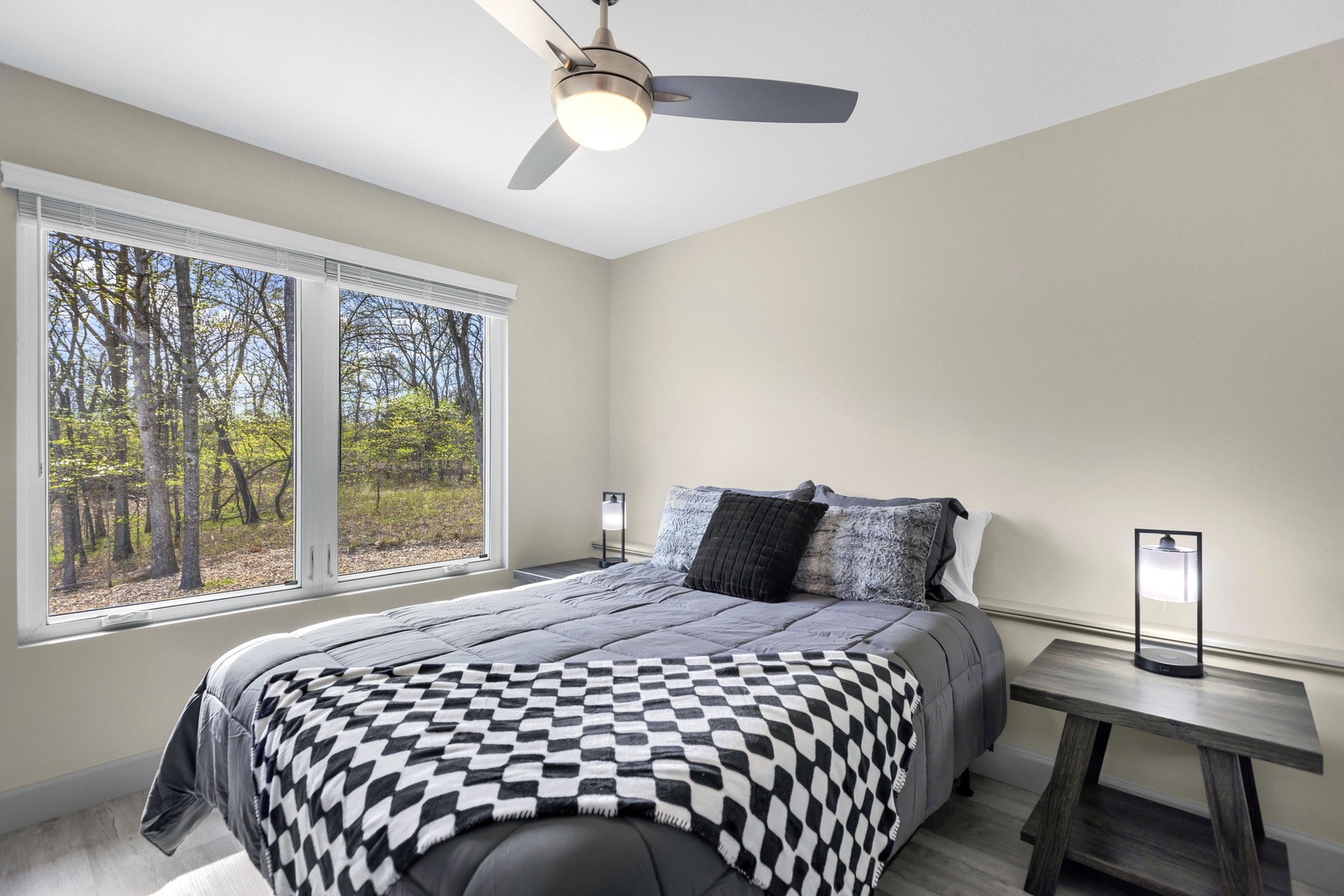 Relax in the second bedroom adorning a queen bed & nature views