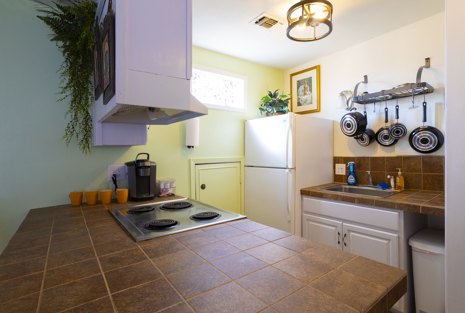 The airy kitchen offers ample space & all the comforts of home