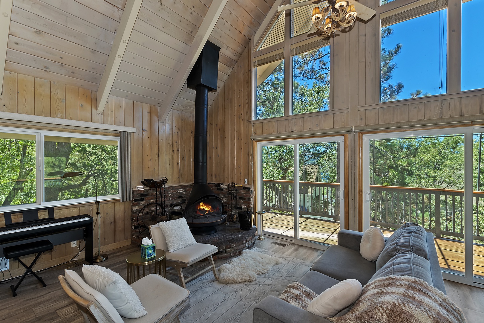 Bright living room with queen sofa sleeper, fireplace, and deck access