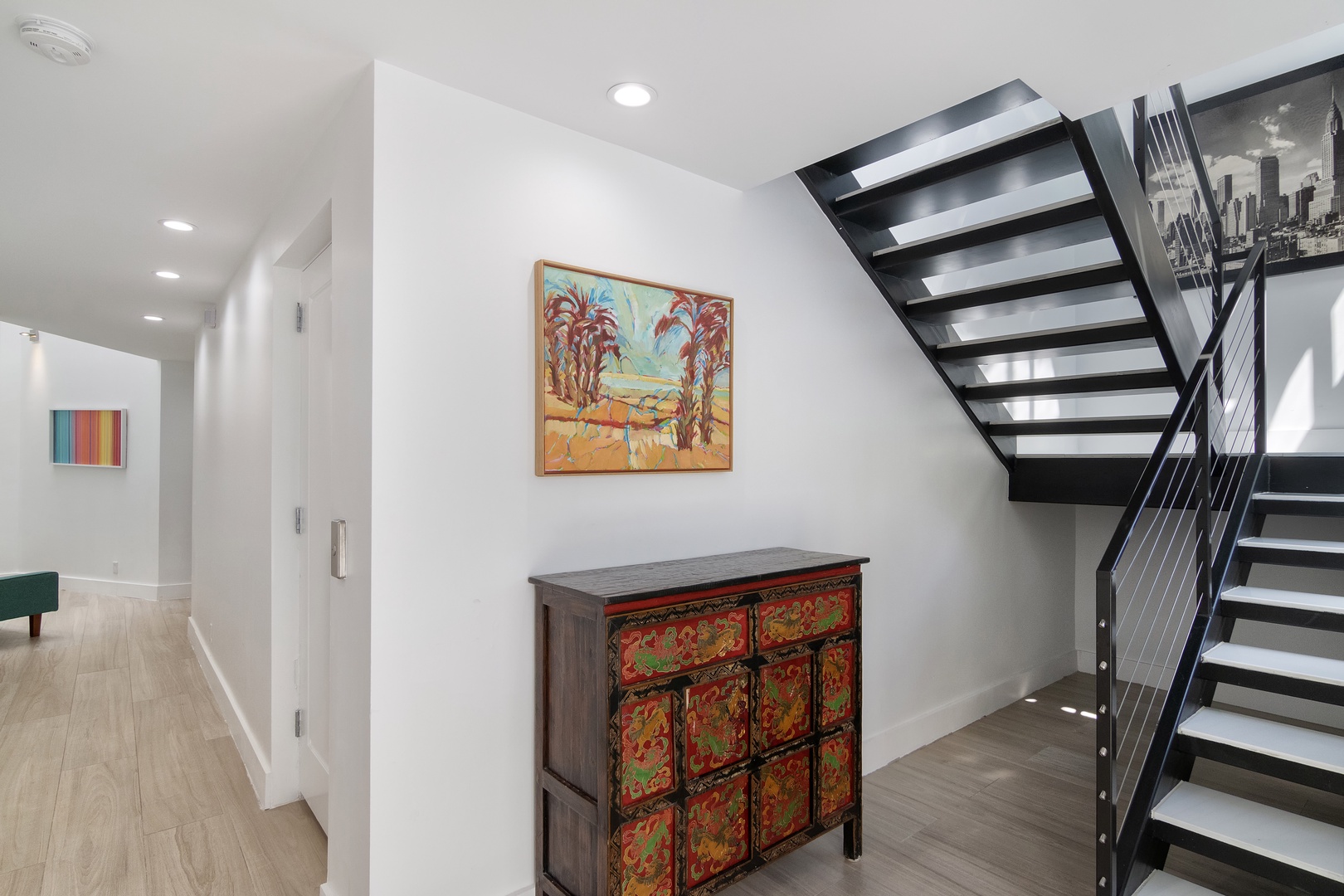 Ascend the sleek, open staircase to the second floor living spaces