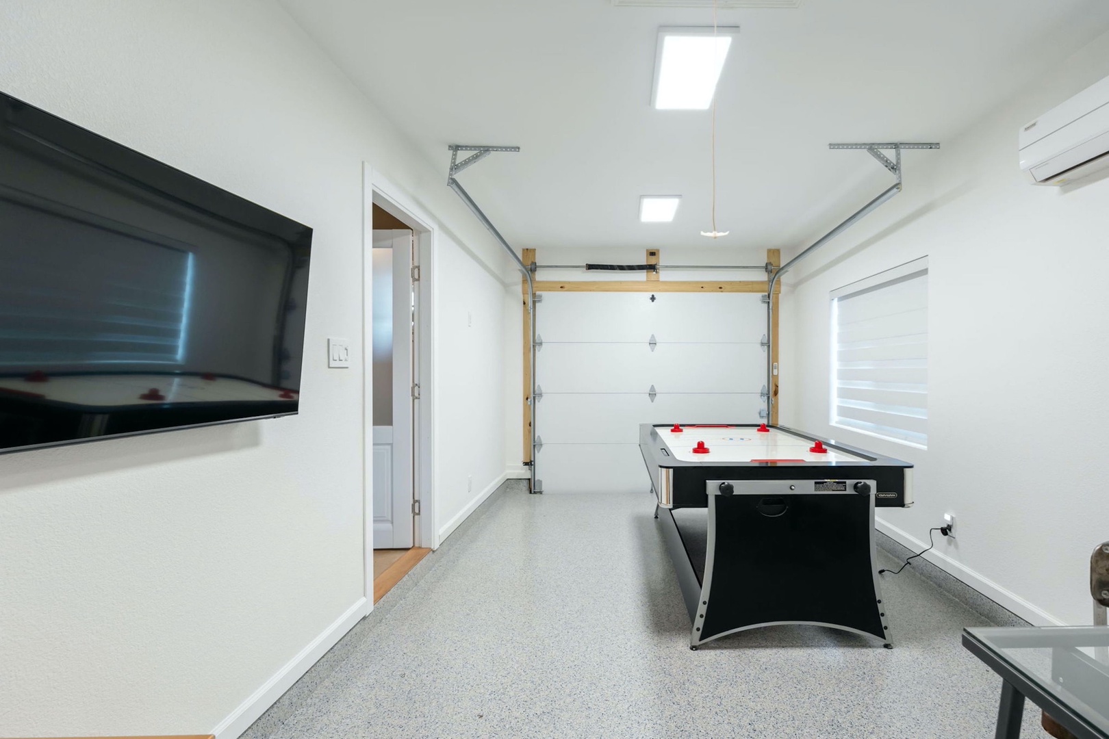 Get competitive with a round of air hockey in the garage game room