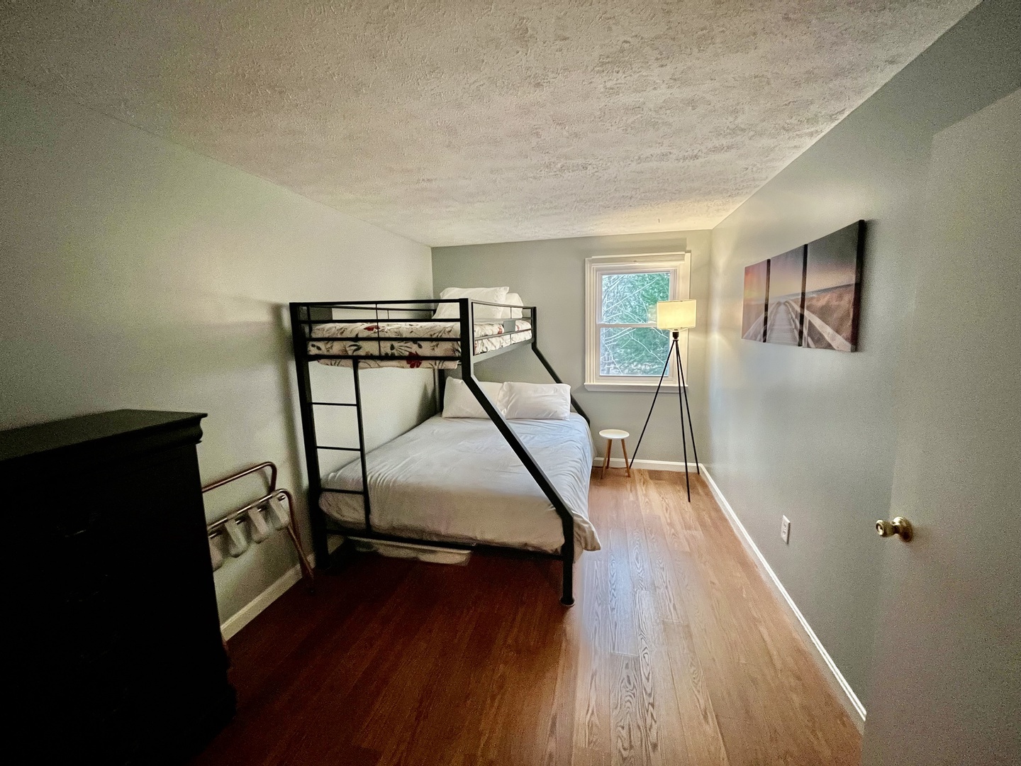 This bedroom retreat offers twin over queen bunkbed and cozy reading area