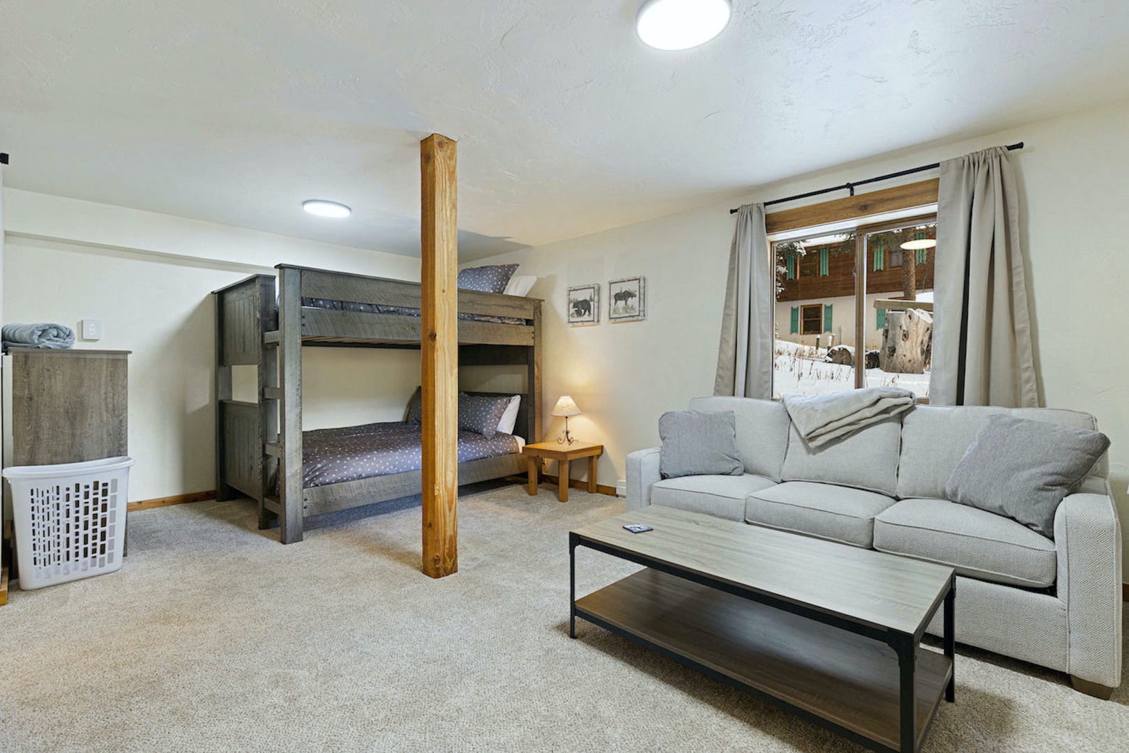 The lower level features a queen sleeper sofa, queen bunks, full bath, & Smart TV