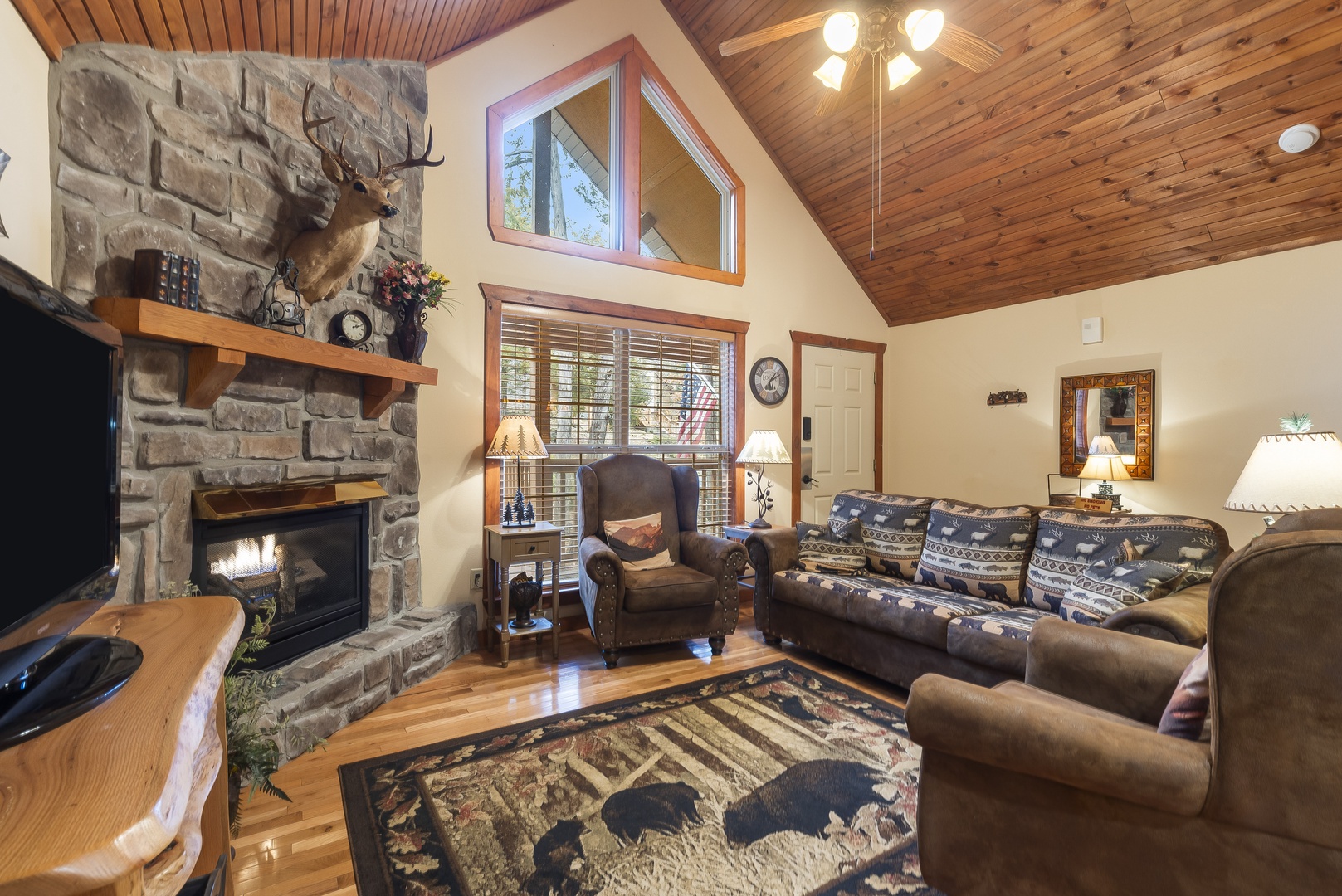 Living space with sofa sleeper, seasonal fireplace, and TV