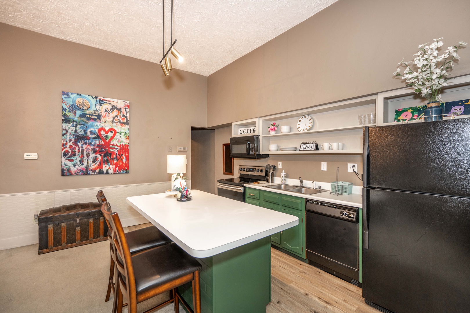 The chic, open kitchen offers ample space & all the comforts of home