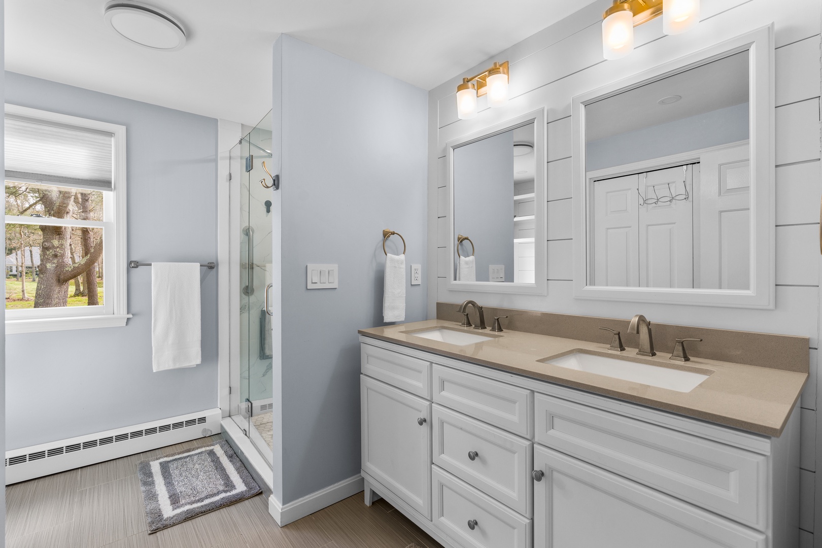 The full bath on the main level offers a double vanity & glass shower