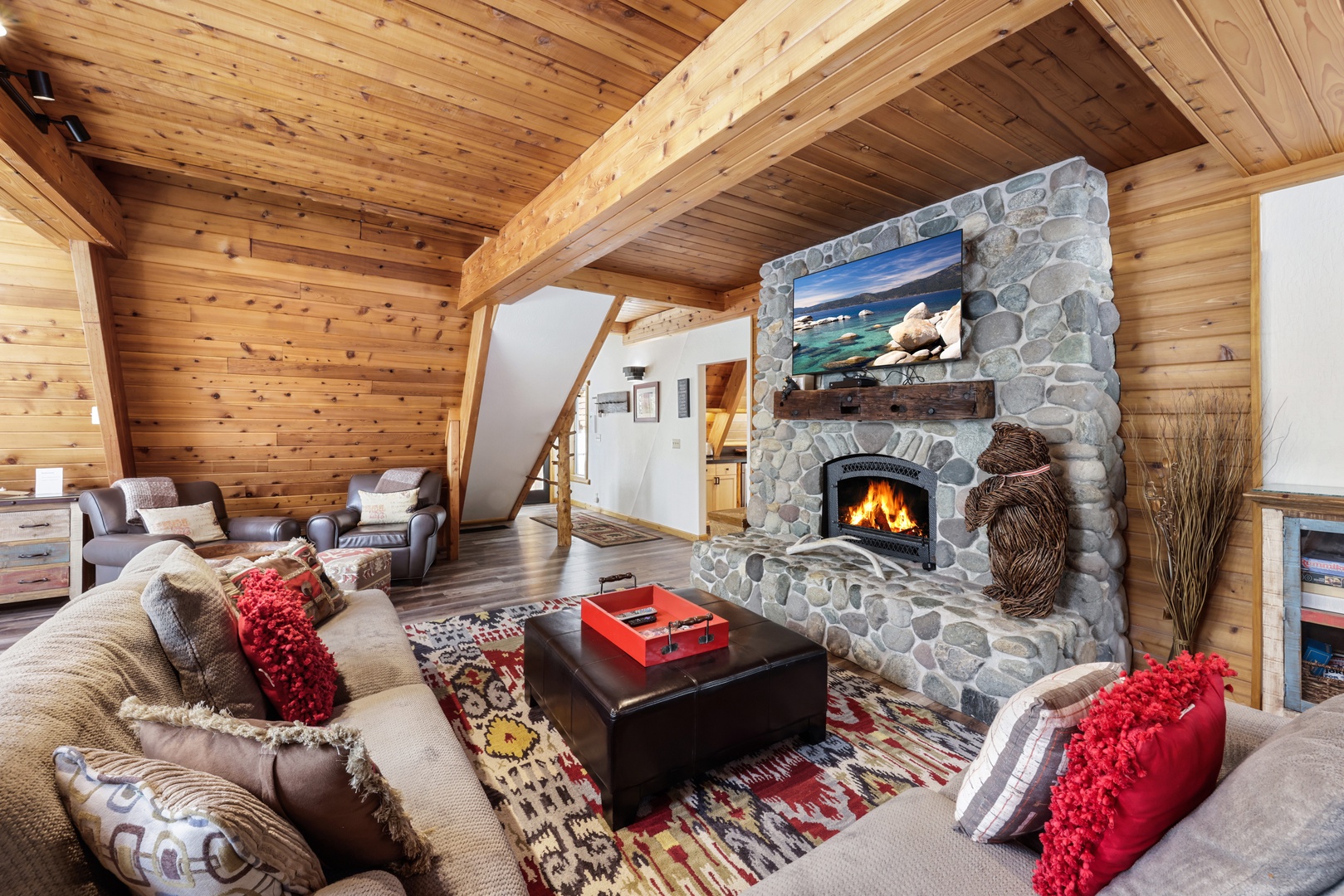 Cozy and spacious living area with TV and fireplace
