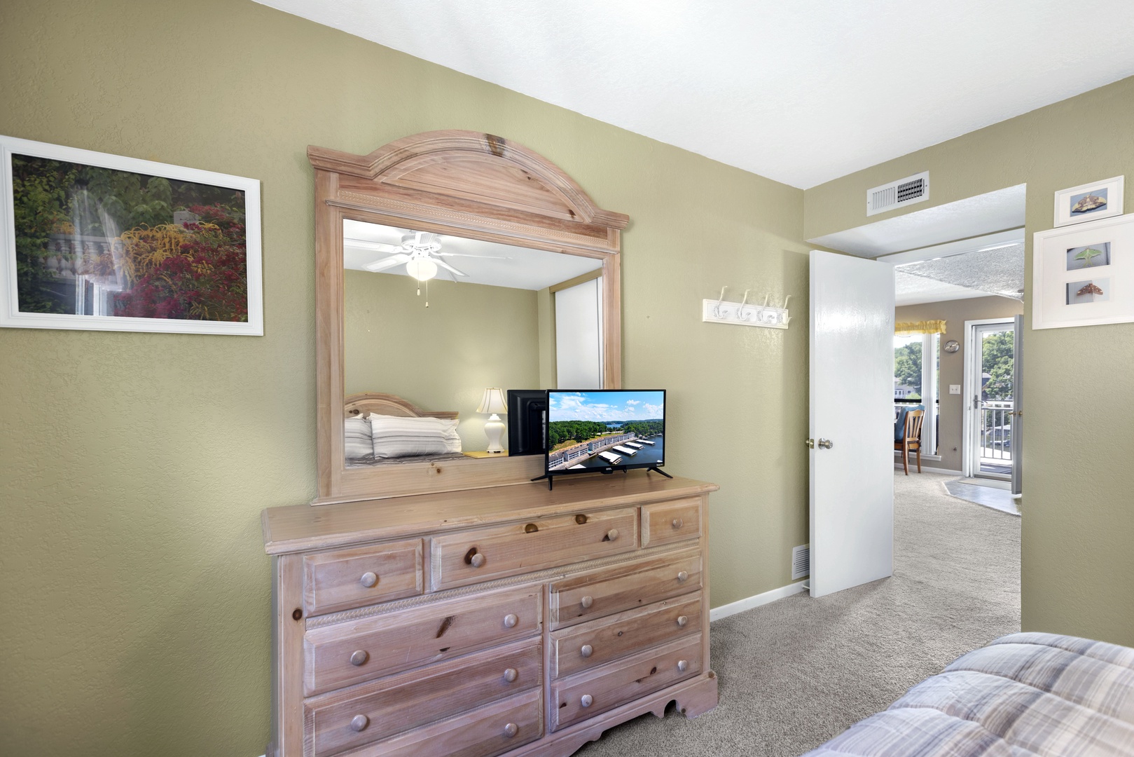 The master bedroom retreat showcases a plush queen bed, ceiling fan & smart TV