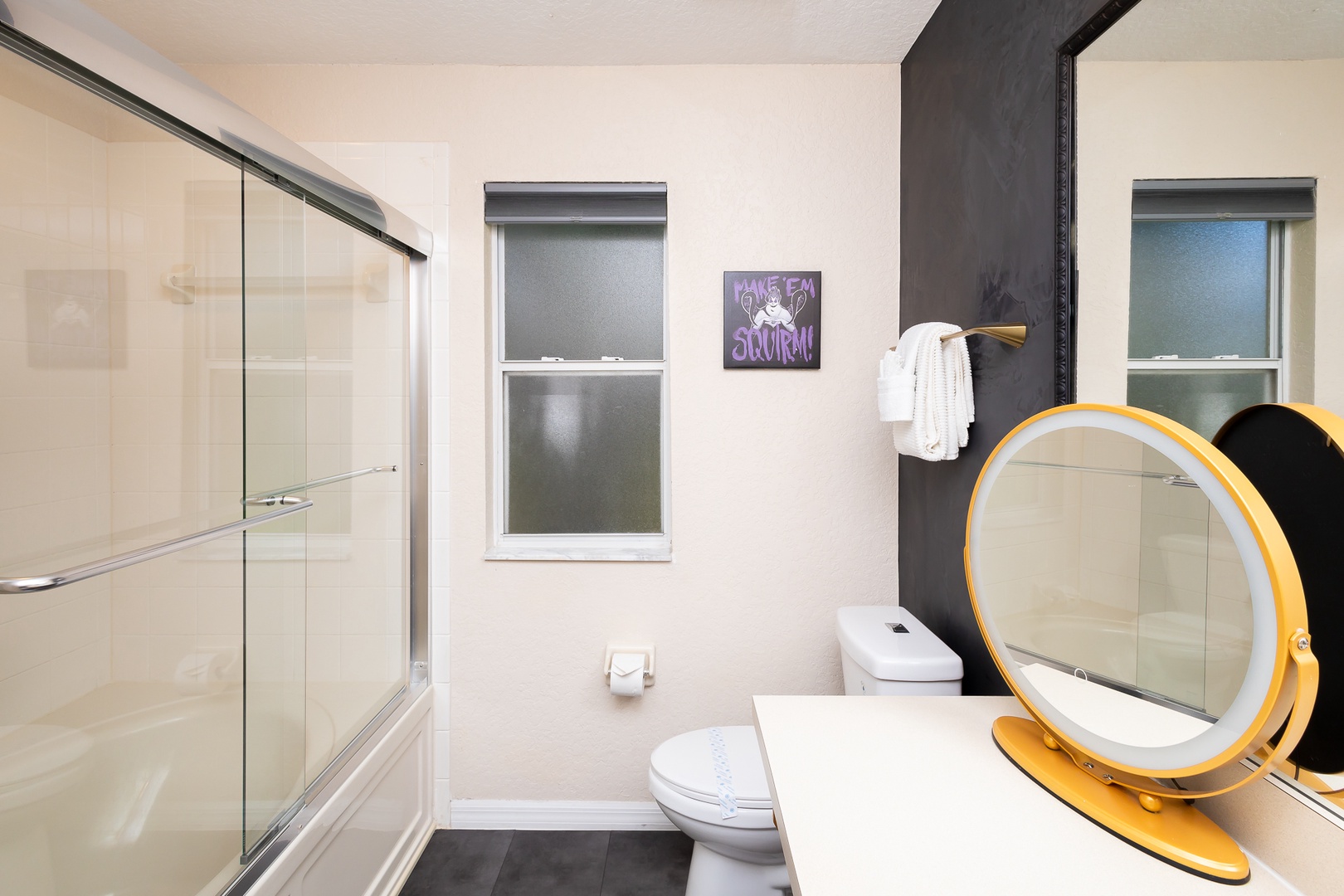 The ensuite off the king bedroom features a single vanity & shower/tub combo