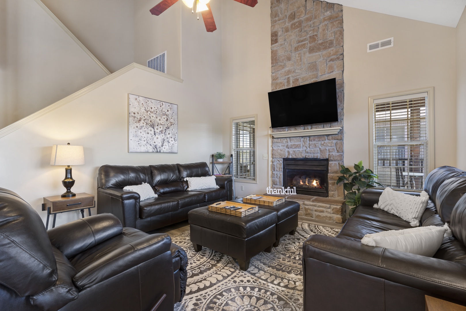Spacious open living space with TV, fireplace, and deck access