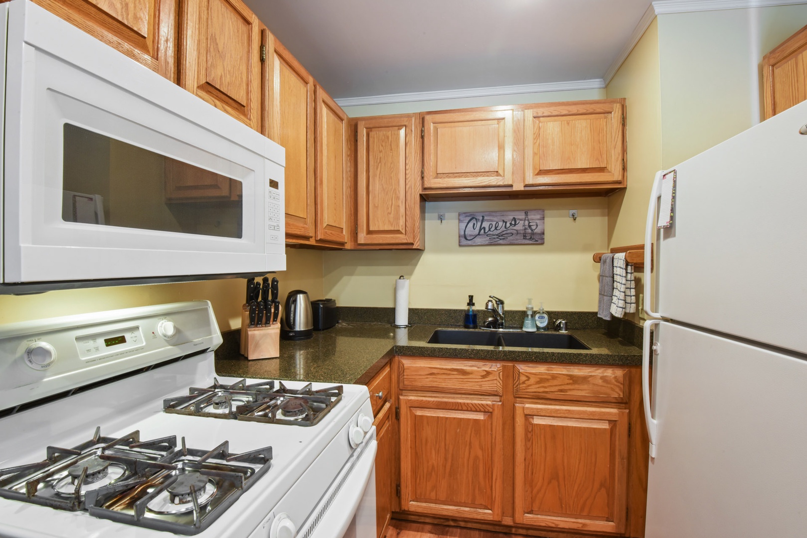 Fully stocked kitchen includes a toaster, coffee pot, wine open & more