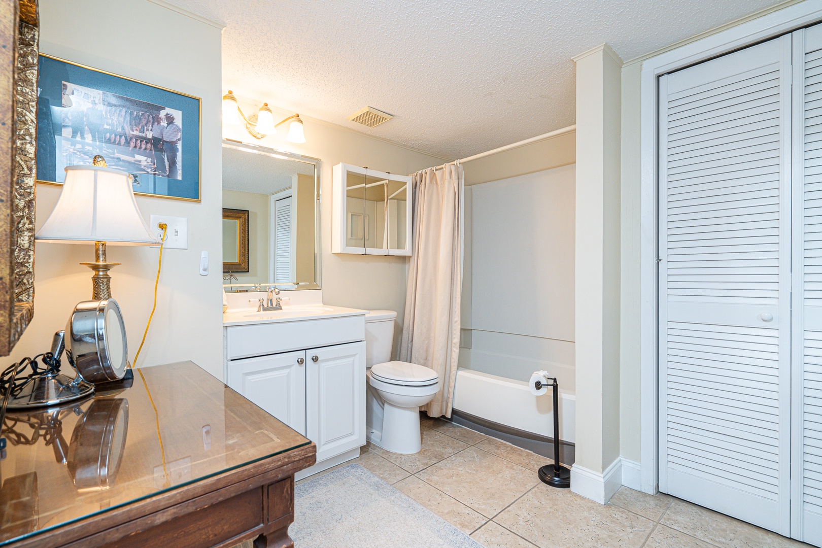 The final full bathroom showcases a single vanity & shower/tub combo