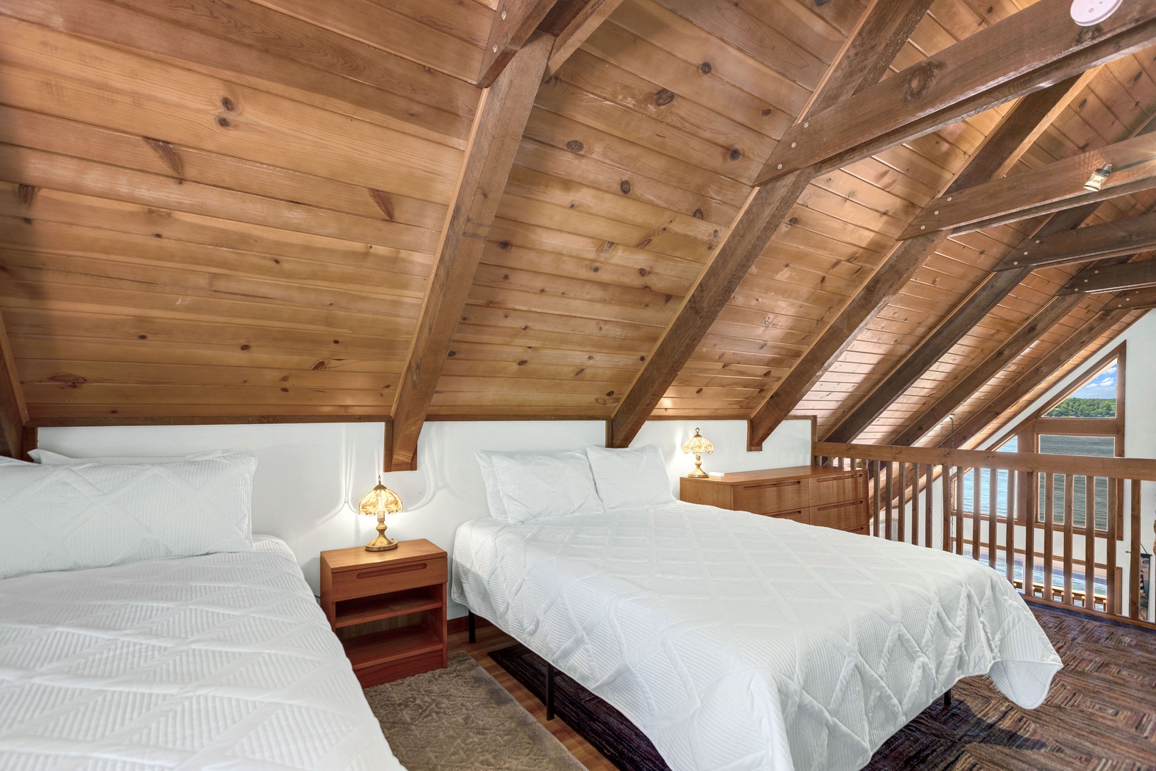 The airy loft boasts a trio of plush beds: 2 queens, 1 king & Smart TV