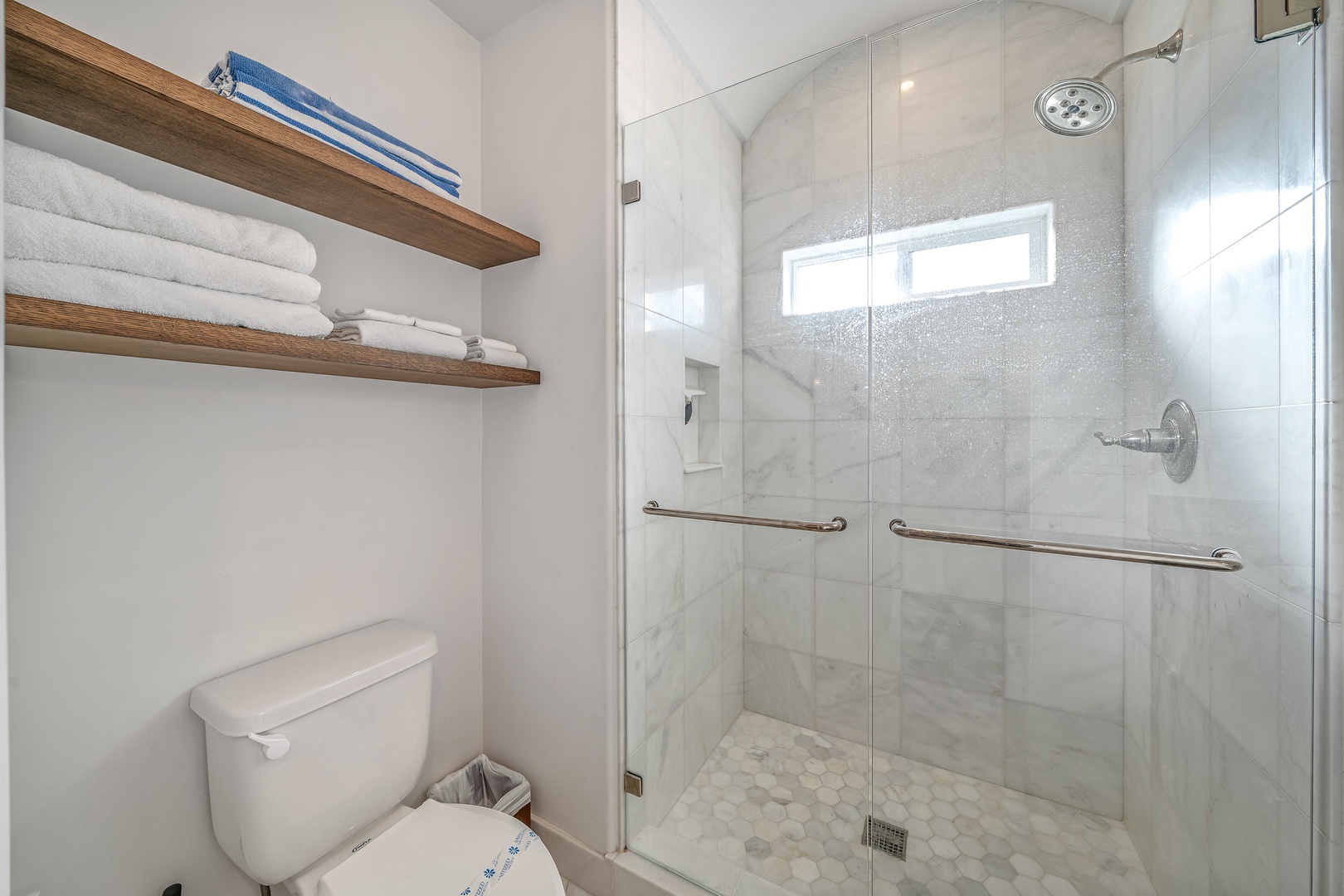 The full bathroom includes a single vanity & spa-like glass shower
