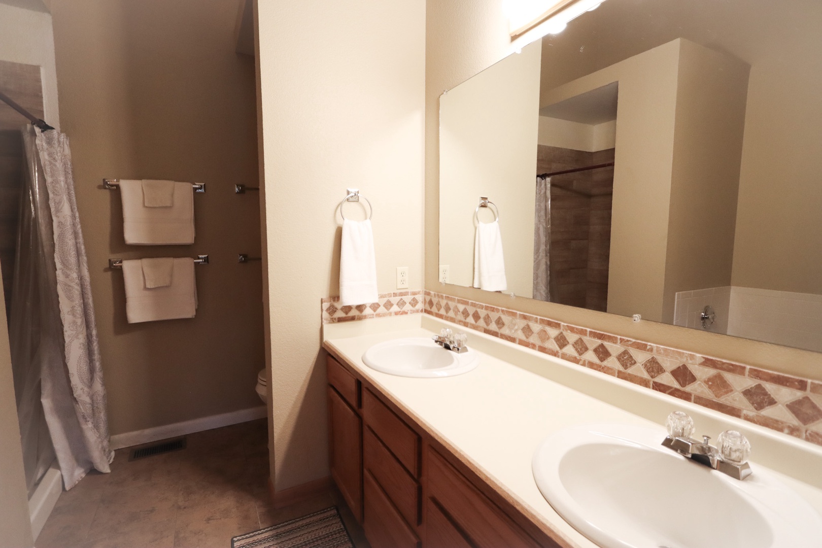 The private full bath off the loft includes a double vanity & walk-in shower
