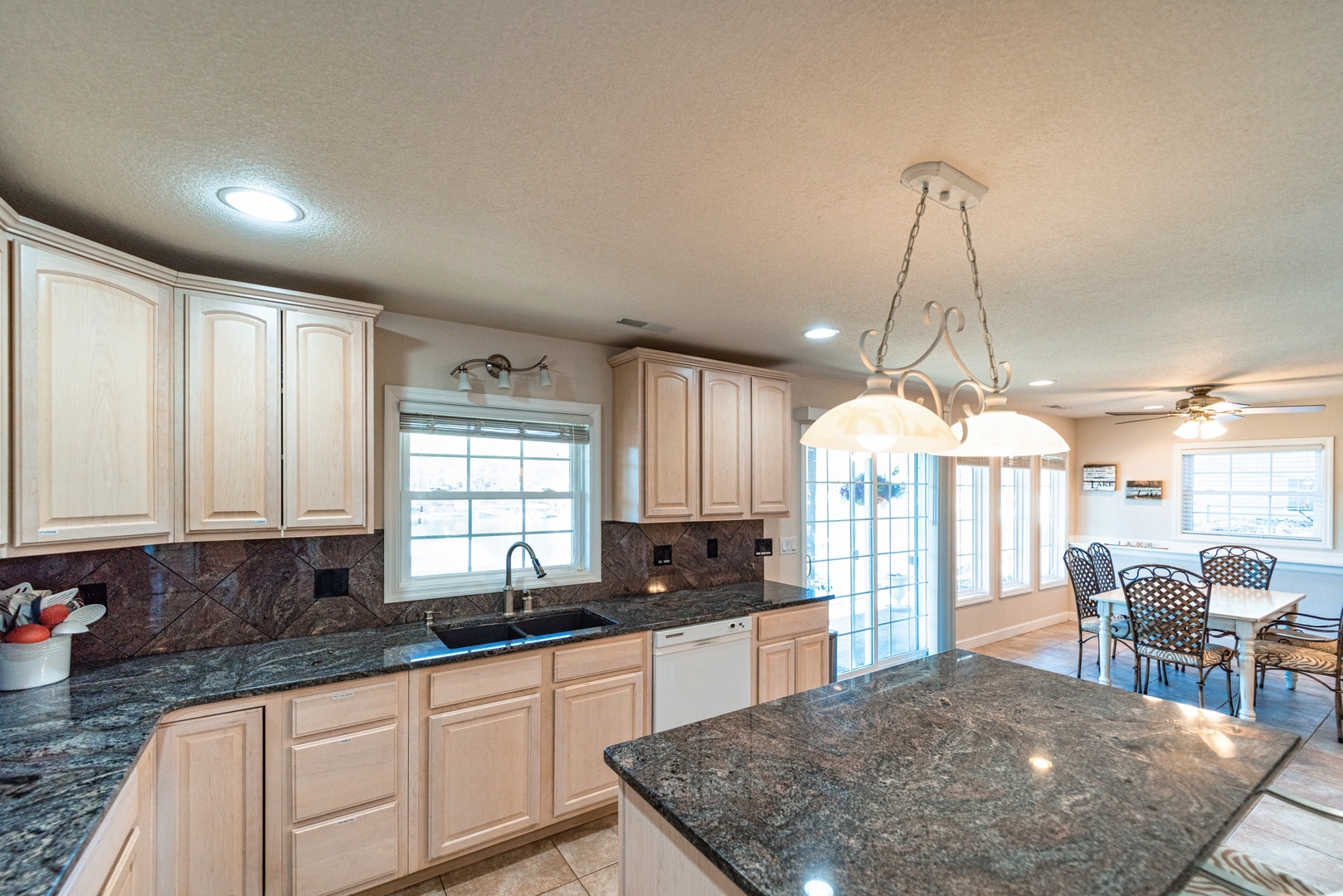 Downstairs, the open kitchen offers ample space & all the comforts of home