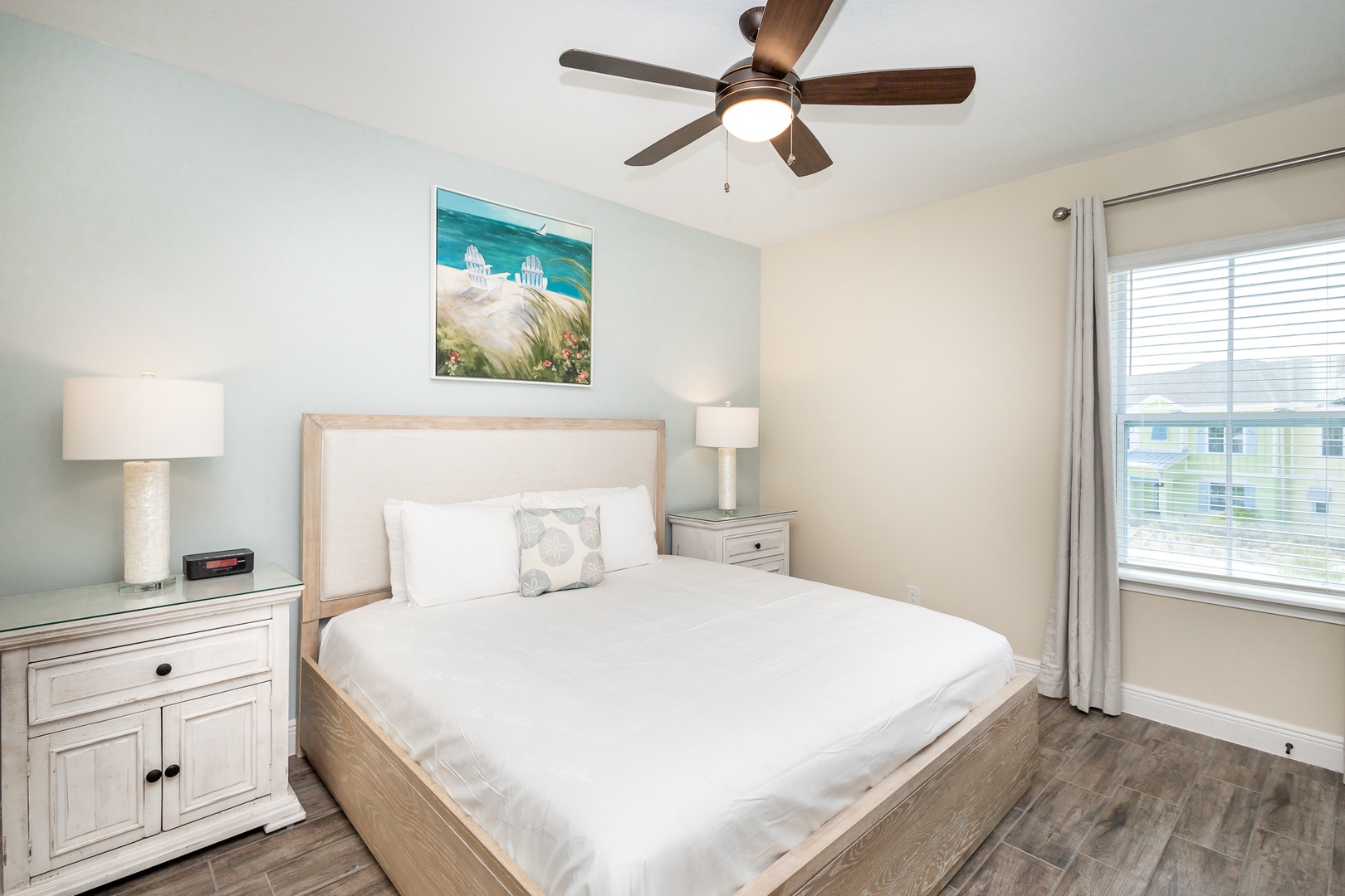 The king bedroom offers a ceiling fan, Smart TV, & plenty of space to unwind