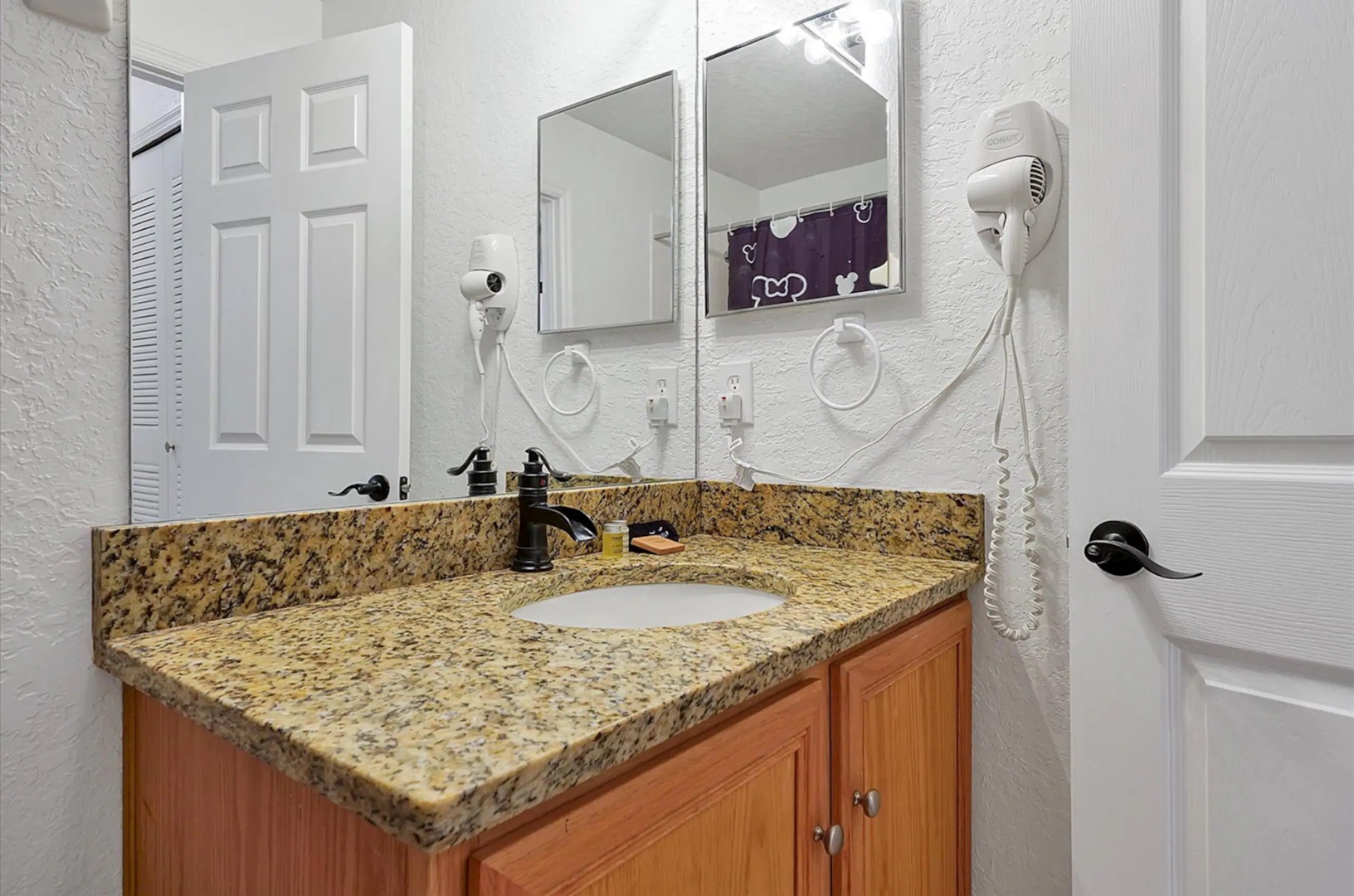 This hall bath features a single vanity & shower/tub combo