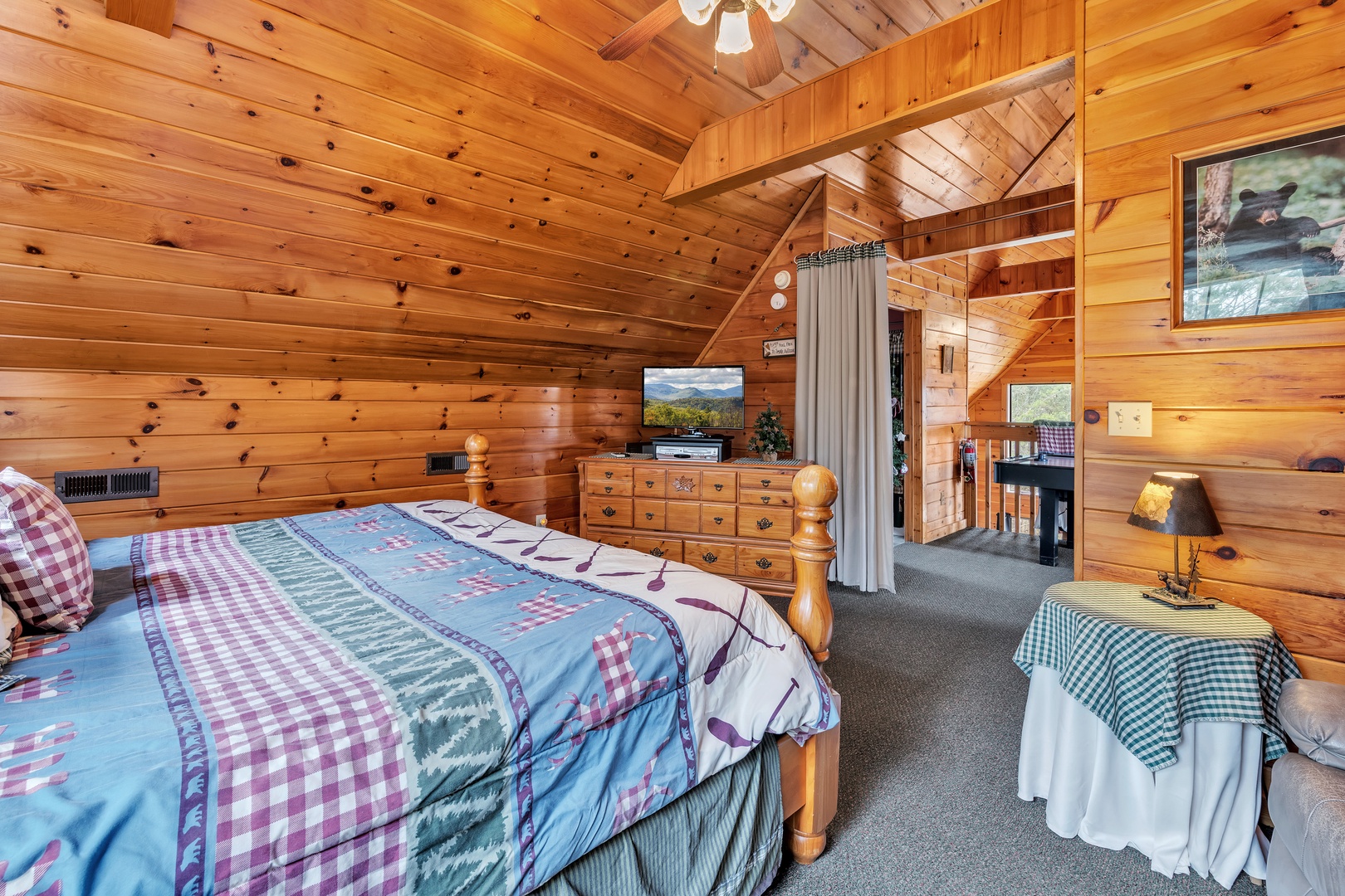 The loft sleeping area includes a king bed, full futon, cozy recliner, & Smart TV
