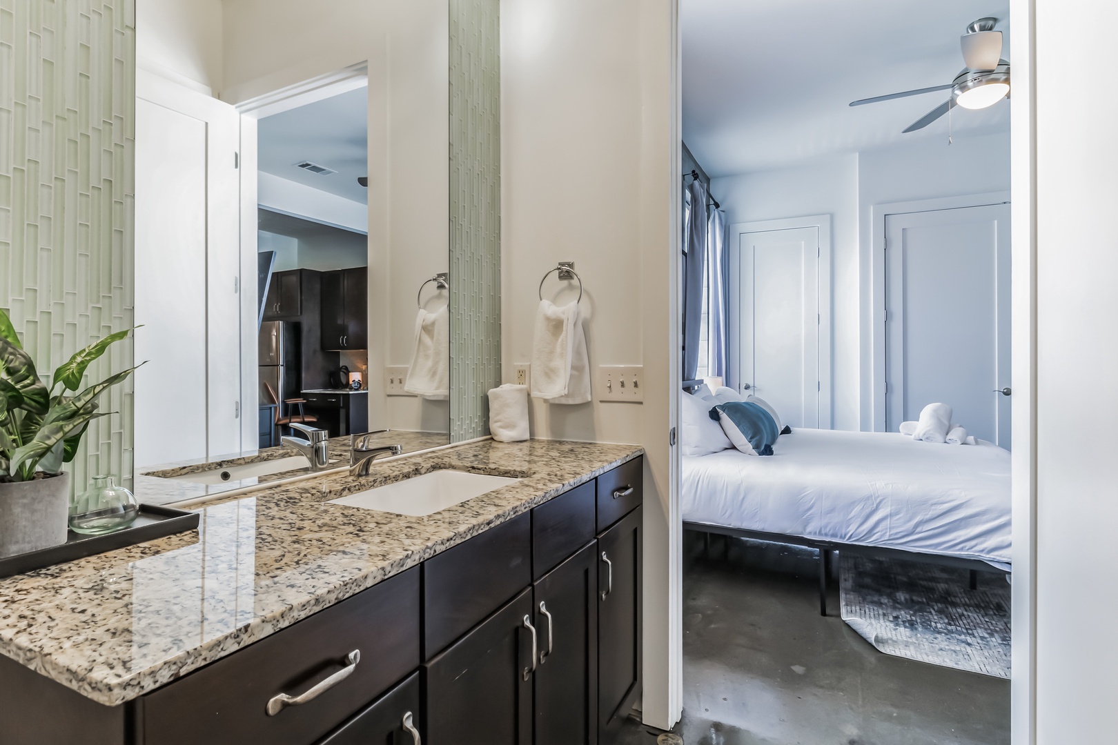 The primary bathroom boasts a spacious vanity and a combined shower/tub