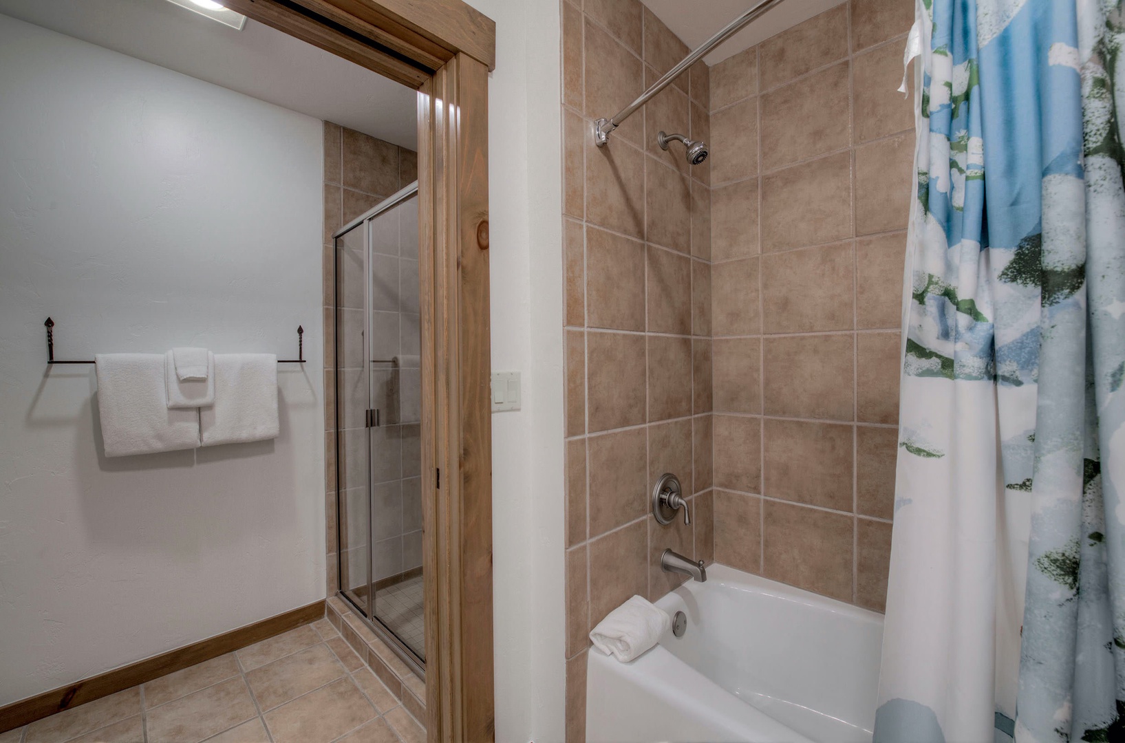 Main bathroom with dual sinks and shower/tub combo
