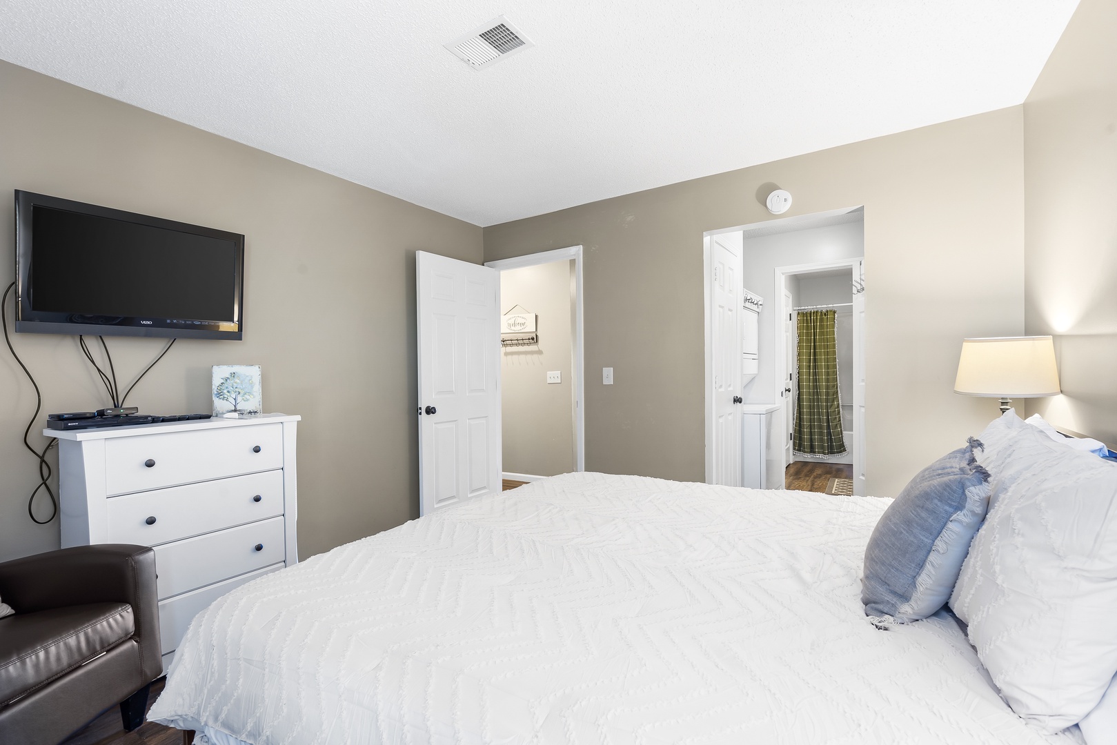 The master suite in Unit 20 boasts a plush king-sized bed, ensuite, & TV